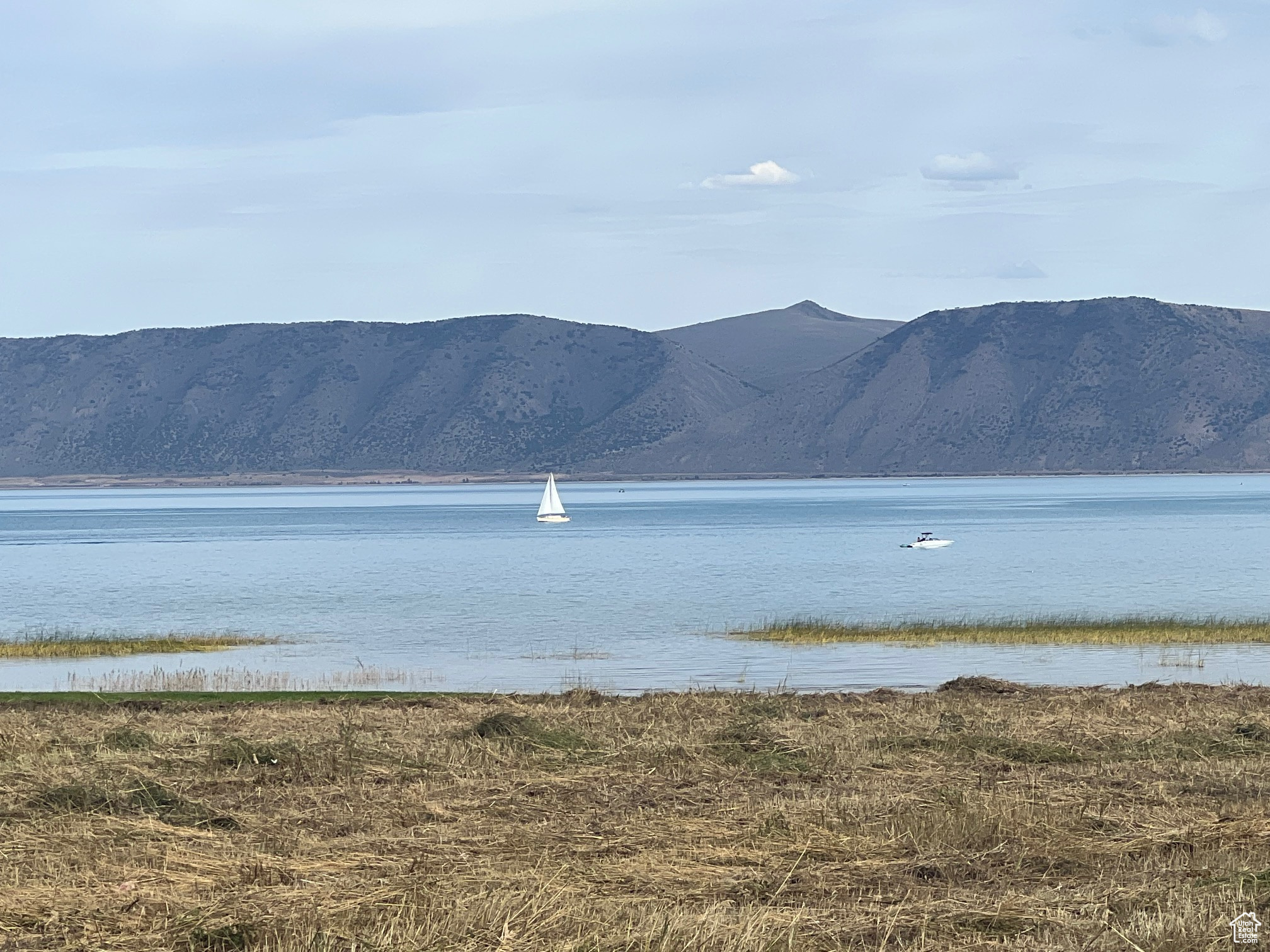 Unique, highly sought after scarce ~1.7 ACRE parcel fronting the biking, jogging, walking trail across from the road from the Bear Lake State Park Marina entrance and the Marina beach/south lagoon bay.  Enjoy your front row veranda views of the bay as yachts, sail boats, ski/surf and fishing boats  come and go from the Marina from sunrise to sunset. This is your extraordinary parcel to build legacy family resort lodge(s).  Relatively flat lot offers ample space for private sports courts, swimming pool and off-road toys/snowmobiles. Private entrance via Lockwood.  Short walking distance to both the Marina, beach, and the local grocery store and a few minutes drive/walk to the downtown Garden City restaurants and shopping.(Adjacent owner of ~1 acres south of this property is interested in co-development; call for more information.)