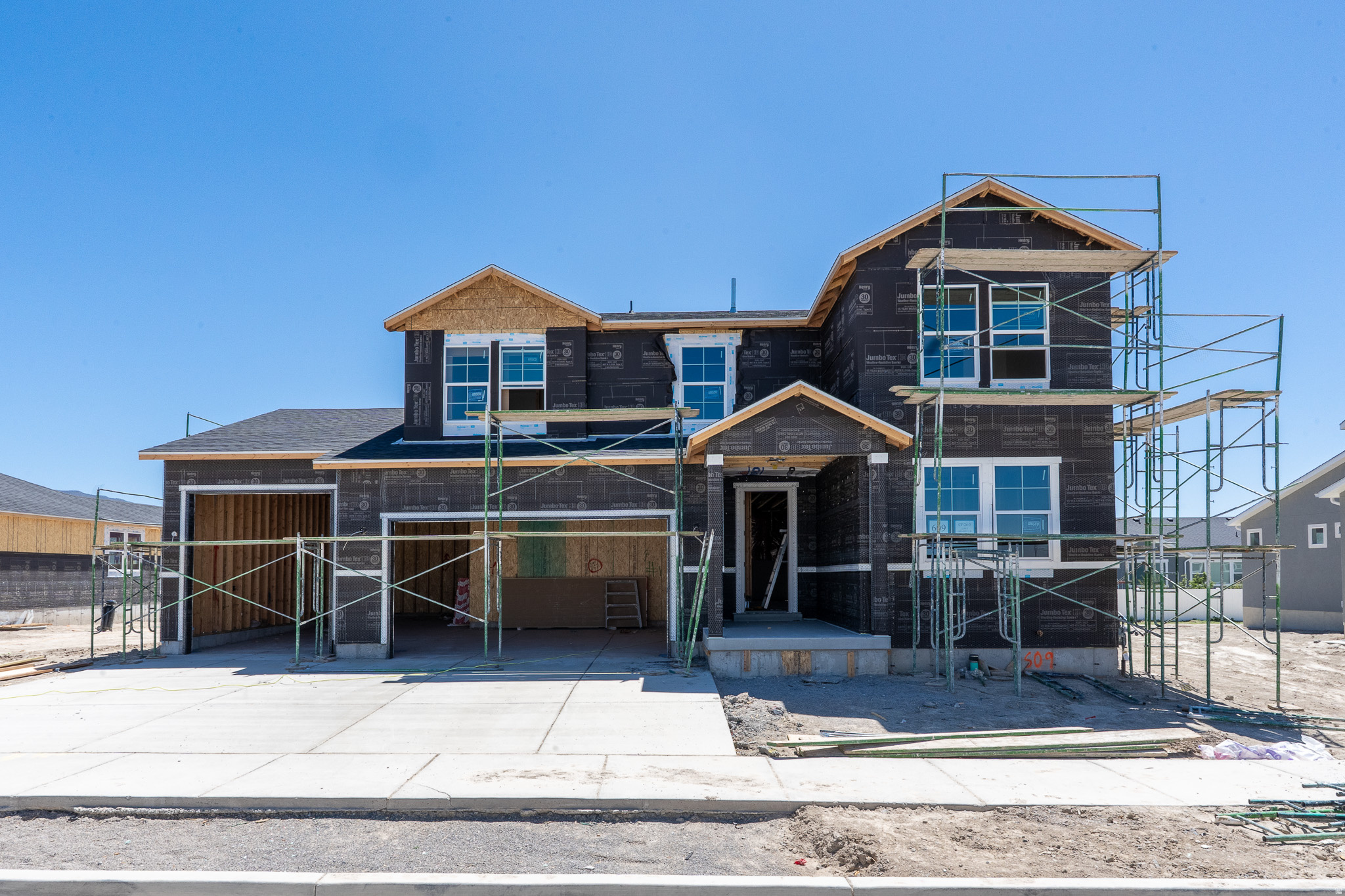 NO HOA! Spacious and versatile, the Raybun in Sunset Flats offers room to live, grow, and entertain on a 0.25-acre homesite. This 5-bedroom, 3-bath home features 2,538 sq. ft. of finished space with a full unfinished basement, bringing the total to 3,639 sq. ft. The main level is designed for flexibility, featuring a guest bedroom and full bath, plus an open-concept great room ideal for everyday living. The gourmet kitchen stands out with Greyhound cabinetry, quartz countertops, a center island, and built-in appliances, all flowing seamlessly into the dining and living areas. A covered deck extends your living space outdoors, perfect for relaxing or entertaining.  Upstairs, a versatile loft and convenient laundry room enhance functionality, while the spacious primary suite offers dual vanities, a separate tub and shower, and a walk-in closet. Additional bedrooms provide plenty of room for family, guests, or a home office. A rare 4-bay garage offers exceptional space for vehicles, storage, or hobbies. North-facing lot. Estimated completion June 2026.