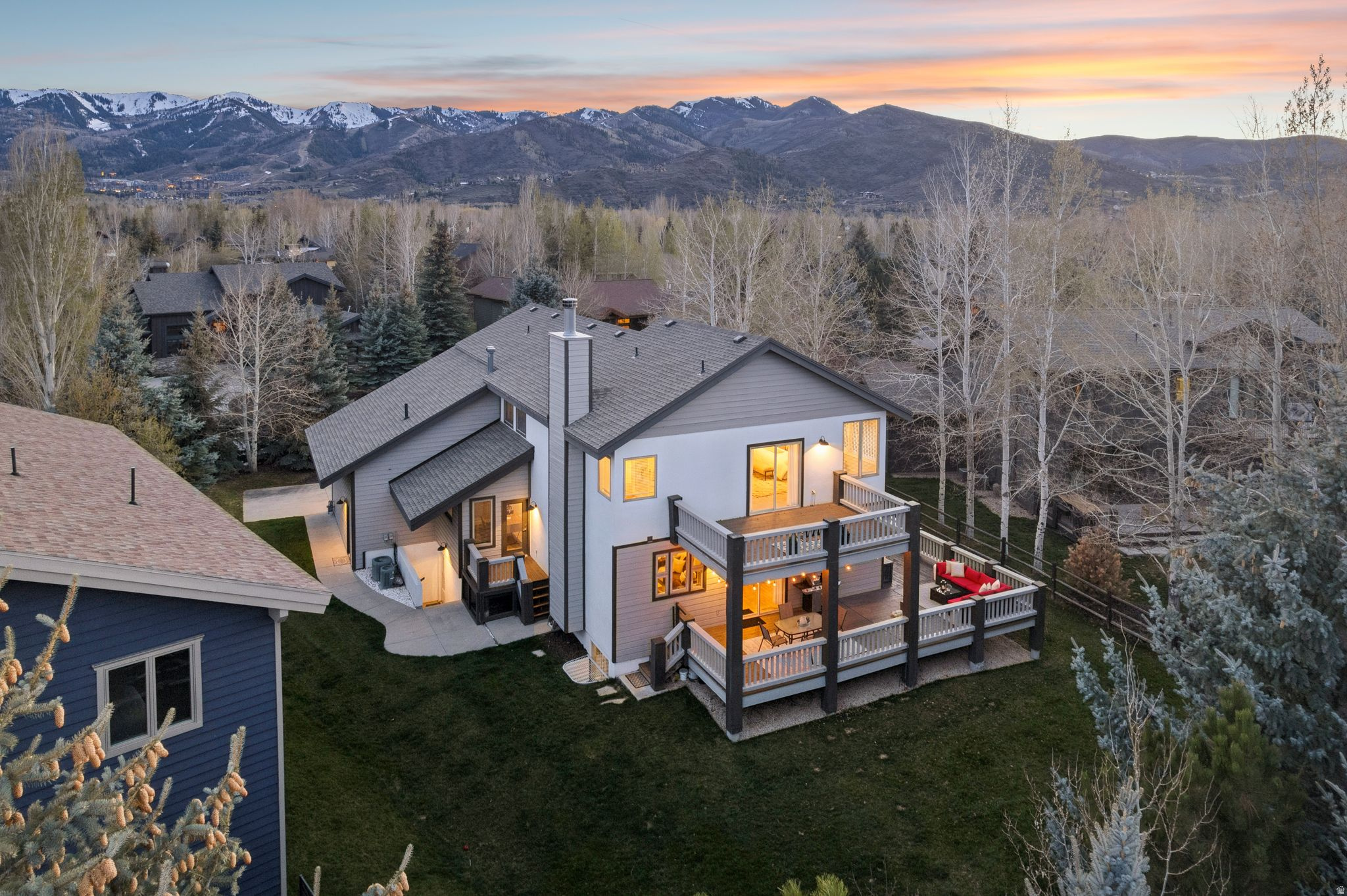 Nicely Appointed Home In Quiet Ranch Place Location.  This beautifully appointed central Park City home is situated in one of the most desired areas within the popular Ranch Place neighborhood. Within 5 minutes of both Willow Creek Park and skiing via Canyons Village base area, this quiet location offers wonderful outdoor living spaces with mature landscaping and a wrap-around deck that is covered in just the right places. Step into the spacious living room with vaulted ceilings connecting to an abundant kitchen/family room. Fluid living areas on the first level are perfectly balanced for work, entertaining and enjoying time at home. The hardwood floor throughout the main level complements the stone fireplaces and the recent updates in the home - especially in the kitchen with new appliances and counter tops. Upstairs an impressive master suite showcases a private, dedicated deck and a large master bathroom. There are two more bedrooms each with a walk-in closet plus a generous office/den complete with an extra bathroom. Overall, the home is full of light and flows nicely for easy living. The lower level has a full kitchen, two more bedrooms and a fun living space with wet bar. There's an over-sized, three car garage to accommodate all your gear for adventure in the mountains. This home represents everything you'll need (and more) for the perfect Park City life.