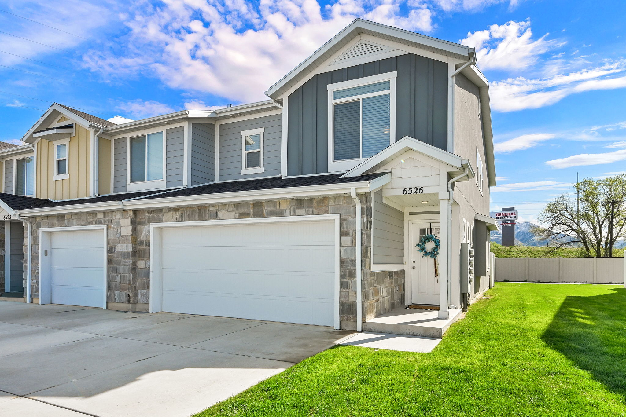 Welcome to this beautiful end-unit townhome, offering privacy with no rear neighbors and breathtaking mountain views. Inside, enjoy quartz countertops, soft-close cabinets, a stylish kitchen backsplash, and pendant lights over the island. The master bath features a tile surround shower with niche, and upgraded carpet and pad run throughout. The fully finished garage includes epoxy floors and built-in cabinets. Built in 2019 and meticulously maintained, this home is pristine and move-in ready. Plus, you're minutes from Hill Air Force Base. With the HOA handling exterior maintenance, you'll enjoy a low-maintenance lifestyle alongside thoughtful upgrades. Come see for yourself!