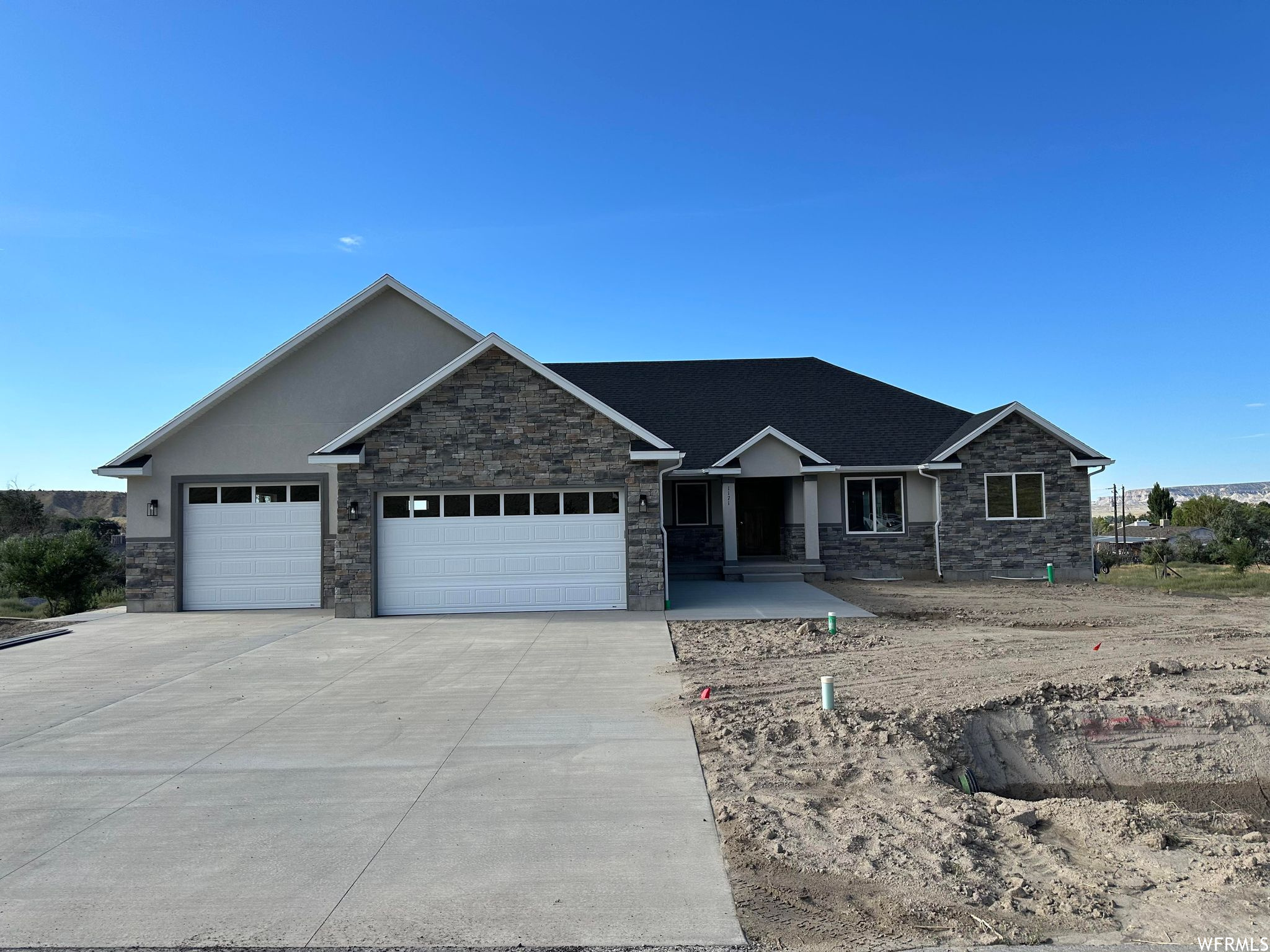 Welcome to this stunning 2023-built rambler located in the desirable Ballpark Subdivision in Helper, Utah! Situated on a spacious 0.60-acre lot, this beautifully designed home offers over 4,000 square feet of living space with 3 bedrooms, 2 bathrooms, and room to grow in the mostly unfinished basement. Enjoy true single-level living with vaulted ceilings, a spacious open layout, and a thoughtfully designed kitchen featuring granite countertops and modern finishes. The home includes both a covered and open patio, perfect for entertaining or taking in the peaceful mountain views. Additional features include a attached 4 car garage, RV parking, a basement entrance, and a secluded yard offering privacy and space. With quality construction, stunning surroundings, and endless potential, this home is a rare opportunity you won't want to miss!