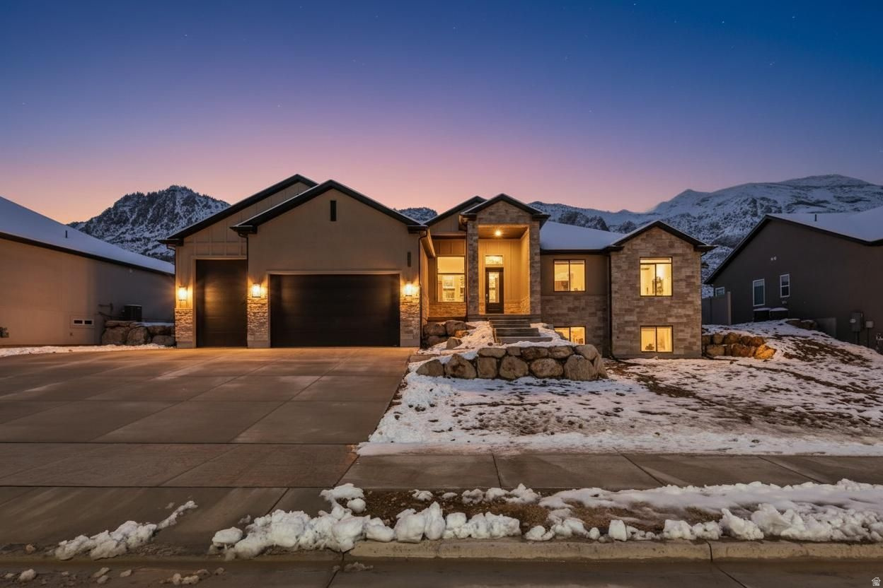 Move-In Ready & Designed to Impress! Step into this beautifully finished 7-bedroom rambler where space, comfort, and thoughtful design come together effortlessly. From the moment you enter, you'll feel at home in the bright, open layout highlighted by soaring vaulted ceilings and a warm, inviting gas fireplace-perfect for relaxing or gathering with loved ones. At the heart of the home, the gourmet kitchen shines with custom cabinetry, soft-close doors, elegant hardware, and charming glass-front accents. Premium appliances, including a built-in 66" refrigerator/freezer, make this space as functional as it is stunning-ideal for everyday living and entertaining alike. Unwind in the luxurious primary suite, your private retreat featuring a soaking tub, oversized shower, dual vanities, and a spacious walk-in closet. The fully finished basement offers incredible versatility with its own kitchenette, four additional bedrooms, a full bath with double sinks, and a second laundry room-perfect for guests, extended living, or multi-generational needs. A walk-out design even opens the door for potential ADU options. Outside, you'll find room for all your vehicles and toys with a generous 4-car garage, EV charging outlet, and a concrete RV pad. This home truly has it all-space, style, and flexibility-ready for you to move in and make it your own.