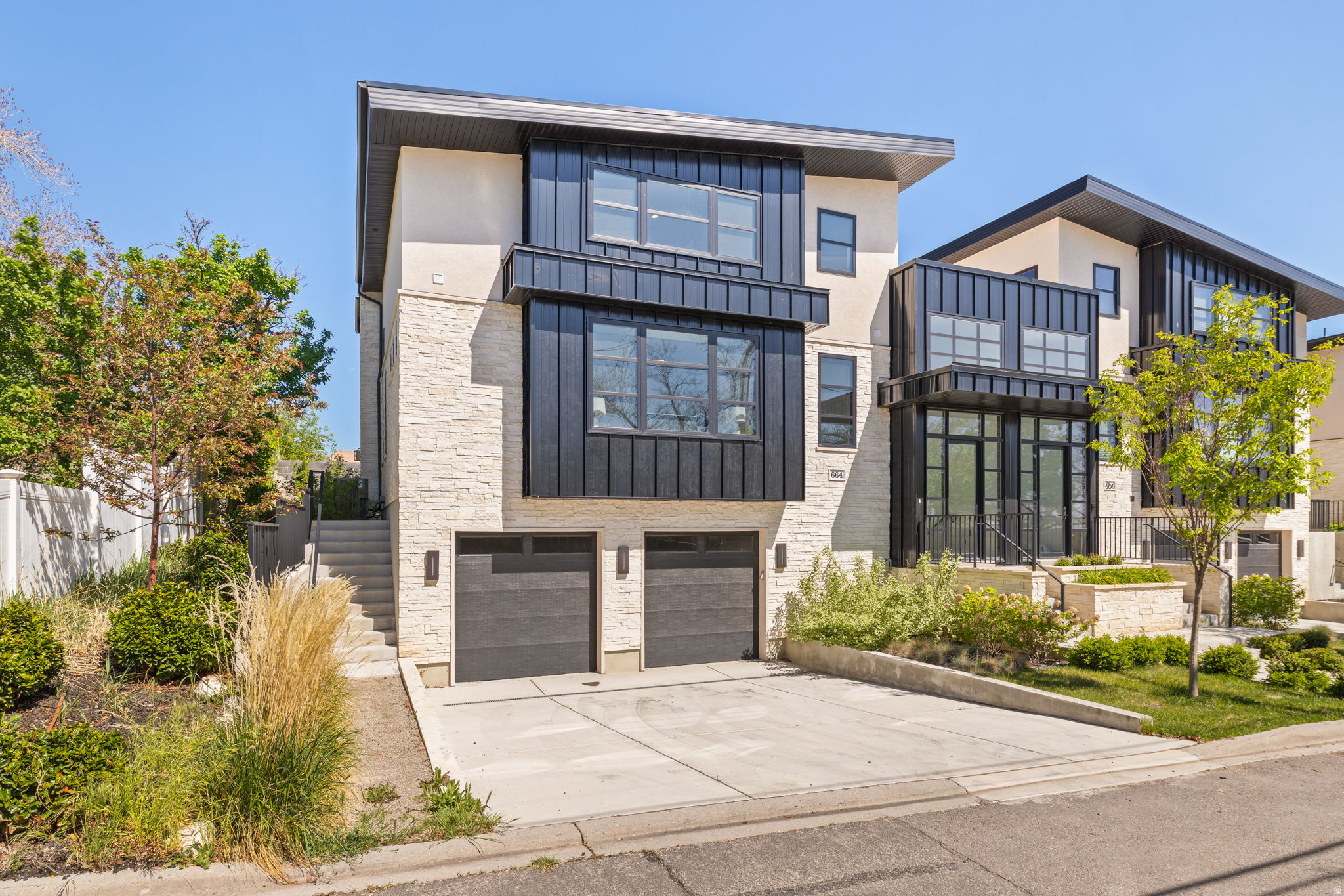 Perched above the heart of downtown Salt Lake City in coveted Capitol Hill, this striking modern home delivers luxury living with panoramic valley and mountain views at every turn. Designed to impress, this new construction residence showcases soaring ceilings, large, and an open-concept layout perfect for both entertaining and everyday living. The chef's kitchen is a true centerpiece, featuring premium Miele appliances, a 48-inch gas range with steam oven, built-in refrigerator, waterfall island, and sleek custom finishes. A dramatic floor to ceiling fireplace anchors the expansive living and dining spaces, while the private primary suite offers a spa-inspired bath with separate soaking tub and shower. A sculptural spiral staircase leads to the upper level, where an airy loft, two additional bedrooms, and a full bath create the ideal retreat for guests or family. The lower level offers exceptional flexibility with 9-foot ceilings, a spacious entertainment room or den, an additional bedroom and bath, laundry, and attached 2-car garage. Every detail has been thoughtfully curated, from high-end Anderson windows and doors to luxurious wool carpeting and designer finishes throughout. Outside, enjoy beautifully landscaped grounds, a private patio, and inviting garden spaces perfect for summer evenings. Just moments from City Creek Canyon, Memory Grove, and the vibrant dining, shopping, and nightlife scene downtown, this is elevated city living at its finest. Don't miss this opportunity, contact us today for your private showing. Square footage figures are provided as a courtesy estimate only. Buyer is advised to obtain an independent measurement.