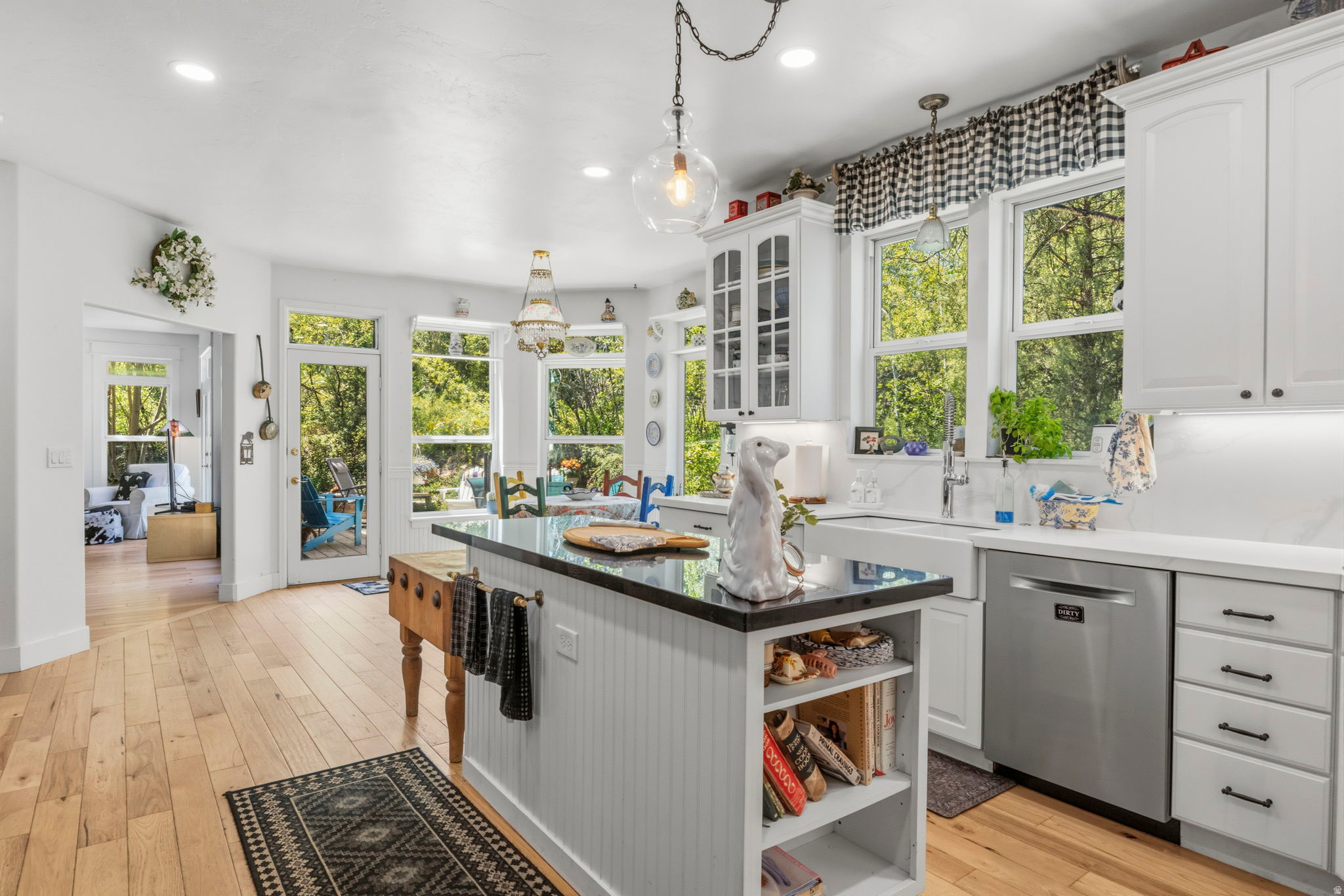 Offered for the first time by its original owners, this beautifully updated Pinebrook home combines timeless mountain elegance with exceptional livability. Backing directly to open space and surrounded by serene views, the home offers a rare sense of privacy and retreat while remaining just minutes from Park City's trails, parks, shopping, dining, and community events. Thoughtfully refreshed from top to bottom, recent improvements include new appliances, fireplaces, paint, flooring, and updated finishes throughout. The main level features rich hickory hardwood floors, complemented by an expansive flagstone entryway--a practical and beautiful mountain-home feature that easily handles snow, mud, and everyday outdoor living. Designed with both gathering and comfort in mind, the home's flowing floor plan offers multiple living spaces, soaring ceilings, abundant natural light, and views from nearly every room. Whether entertaining guests or enjoying a quiet evening at home, the layout provides the perfect balance of openness and privacy. The lower level includes a finished media/theater room and substantial unfinished space ready for future expansion. Additional bedrooms, bathrooms, recreation space, a home gym, or guest quarters can easily be incorporated to suit evolving needs. A south-facing driveway simplifies winter living, while immediate access to trails and open space creates an unmatched connection to the outdoors. Rarely does a home offer this combination of thoughtful updates, flexible living spaces, expansion potential, and a peaceful setting. This is a truly special Pinebrook property that lives as beautifully as it looks.