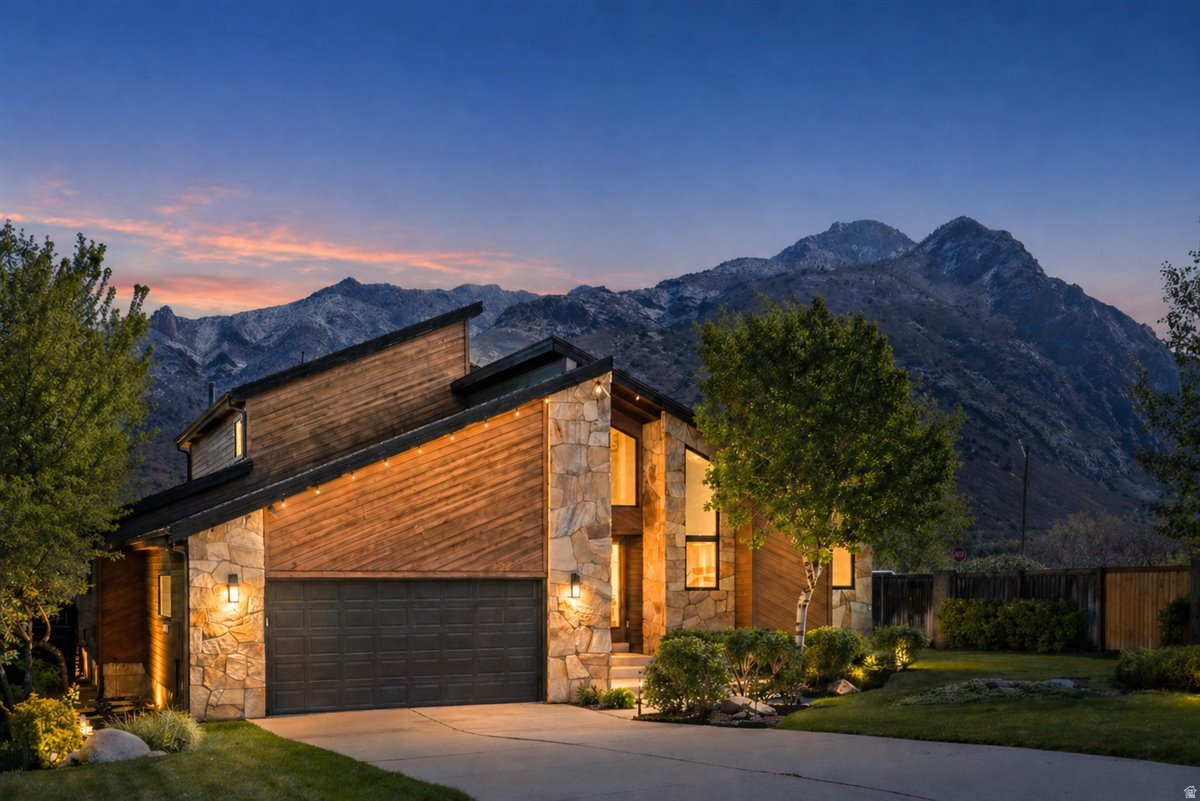 Nestled at the base of Little Cottonwood Canyon in Sandy, just minutes from world-class skiing and some of the best trail systems along the entire east bench, this home is something you feel the second you pull up. The architecture alone sets it apart-perfectly positioned against the mountains in a way that makes it feel like it belongs exactly where it is. Inside, it only gets better. There's a warmth here that's hard to explain unless you've experienced it-rich wood beams and casings give it a grounded, organic feel, while vaulted ceilings and a variety of windows bring in incredible light and frame the trees and mountain views like living artwork. The layout just works, with generous spaces throughout including multiple living and dining areas on the main level, a spacious kitchen with granite countertops, and a tucked-away office nook. Upstairs feels like its own private retreat, with a grand primary suite and loft that take up the entire level, complete with a massive walk-in closet, separate tub and shower, and views that look straight at the face of the mountain. The basement offers even more room to spread out with a large living area, kitchenette, and tons of storage. Outside, the nearly half-acre lot is just as magical-lush, private, and thoughtfully designed with a massive deck, spacious patio, large yard, and a thriving koi pond. There's even room to add a detached garage, additional storage, or even a pool! This home blends original character with meaningful updates, but more than anything, it offers something you don't come across often-a feeling. It's the kind of place you walk into and just know you may never find again.