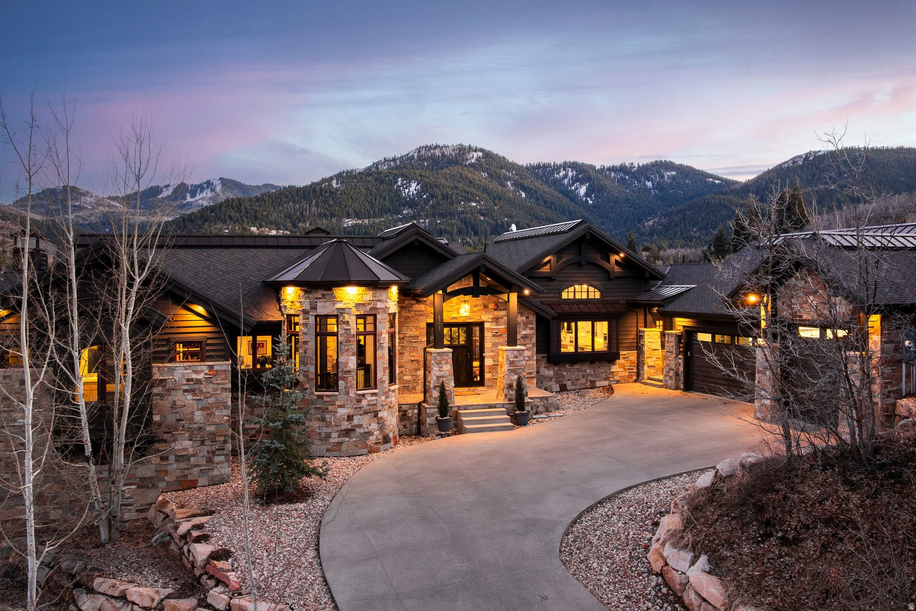 Tucked at the end of a quiet cul-de-sac in a gated community with no highway exposure, this exceptional home offers privacy, open space, and seamless access to both Park City and Salt Lake City. Designed for effortless living, the main level features a beautifully appointed kitchen with a Thermador appliance suite, walk-in pantry, and easy flow to the mudroom, laundry, and oversized garage. A dedicated office provides ample room to work from home without sacrificing a bedroom. The functional floor plan includes a lower-level walk-out with three guest suites, a second kitchen/wet bar, game room, exercise room, and media space, ideal for entertaining. Elevated finishes of stone, slab countertops, hardwood floors, and exposed beams create a warm yet refined mountain aesthetic. Enjoy a private outdoor retreat with a covered hot tub, firepit, and tranquil water feature. A rare oversized garage accommodates up to four vehicles, including Sprinter or RV, with epoxy floors, storage, and dog wash. Quiet, scenic, and move-in ready.