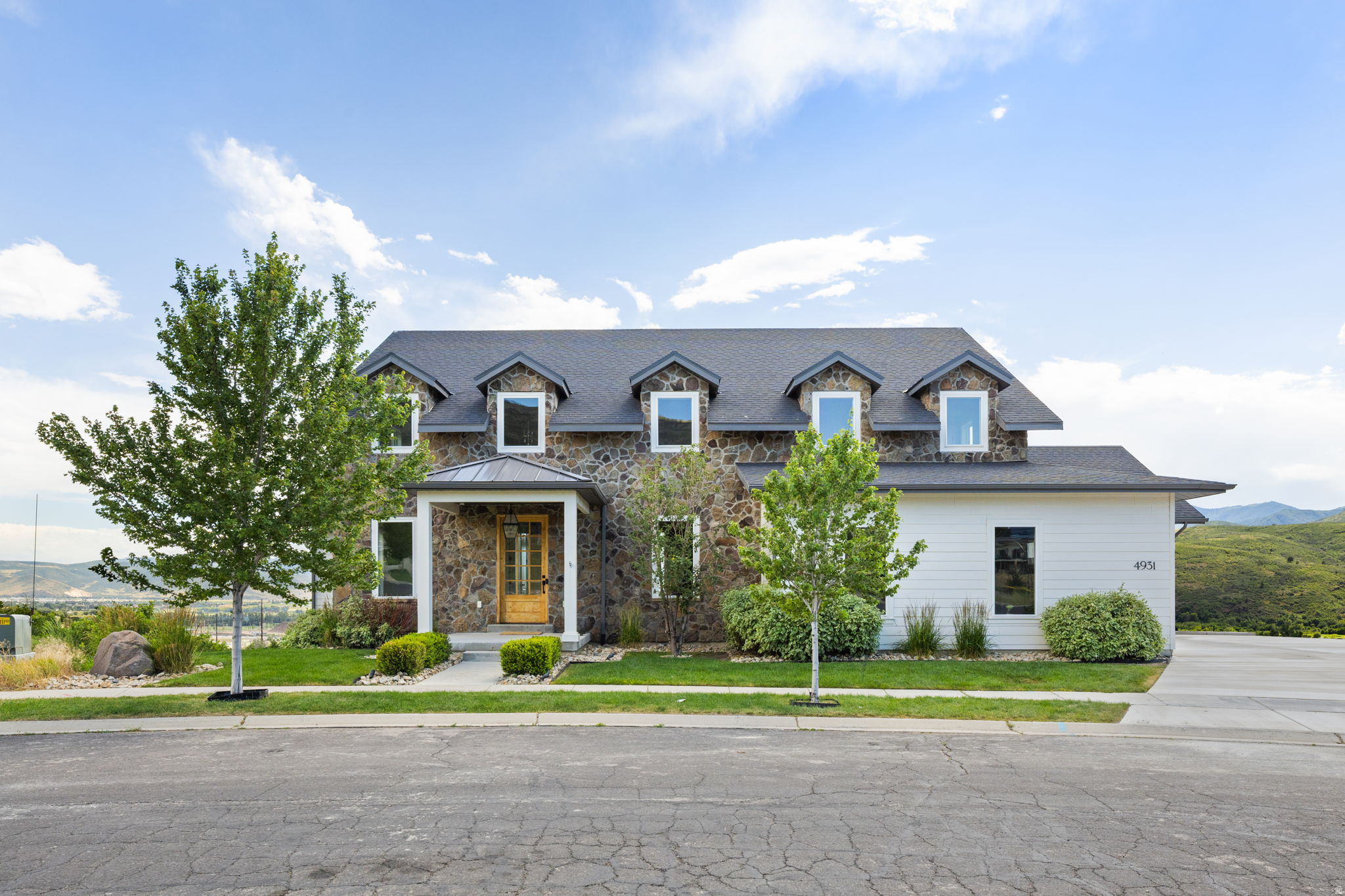 High above the Heber Valley with direct views of Mount Timpanogos, this home combines Southern-inspired architecture with mountain valley living. Over 7,000 square feet of smartly appointed living space on an oversized 3/4-acre lot creates one of the most desirable opportunities in the area. Designed and built with the impressive views in mind, the home features large windows and doors opening to a partially covered deck spanning the back of the home. On the main floor, the primary bedroom is joined by a private office, full laundry room, spacious vaulted living area, and chef's kitchen. Upstairs, a secluded reading loft and three spacious bedrooms each take in the surrounding vistas. The oversized walkout basement is built to entertain, with a full gym and theater room. The home is located 5 minutes from Deer Valley East Village and within 20 minutes of the area's most impressive landmarks, including world-class skiing, Park City Main Street, 8 championship golf courses, and 2 pristine reservoirs. With over half an acre still untouched, the backyard offers room to expand the recreation possibilities on your own property.