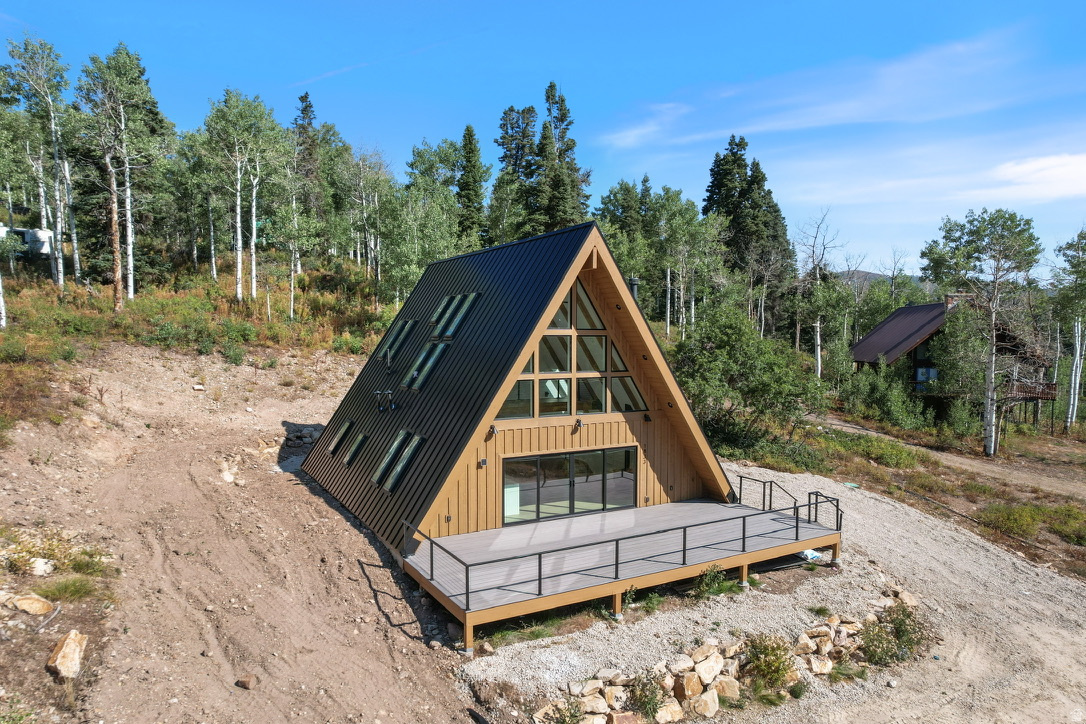 Welcome to your mountain modern A-frame retreat just 15 minutes from Park City. Newly completed in 2025 and never occupied, this pristine 3-bedroom, 2-bath cabin spans 2,021 square feet and blends timeless architecture with high-end finishes and an Instagram-worthy interior. Soaring ceilings, abundant skylights, and walls of windows flood the open-concept great room with natural light, while a luxury kitchen with top-tier appliances and custom details elevates the living experience. Built-in bunk beds add charm and functionality, making the home ideal for hosting family and guests alike.  Step outside onto the expansive front deck to take in sweeping mountain views and frequent wildlife sightings-your own private escape in every season. Conveniently located less than one mile from the winter parking lot, access is simple year-round. APPROVED FOR NIGHTLY RENTALS, this property offers a rare opportunity to own a brand-new, turnkey asset with strong income potential, while still enjoying it as your personal getaway whenever you choose.