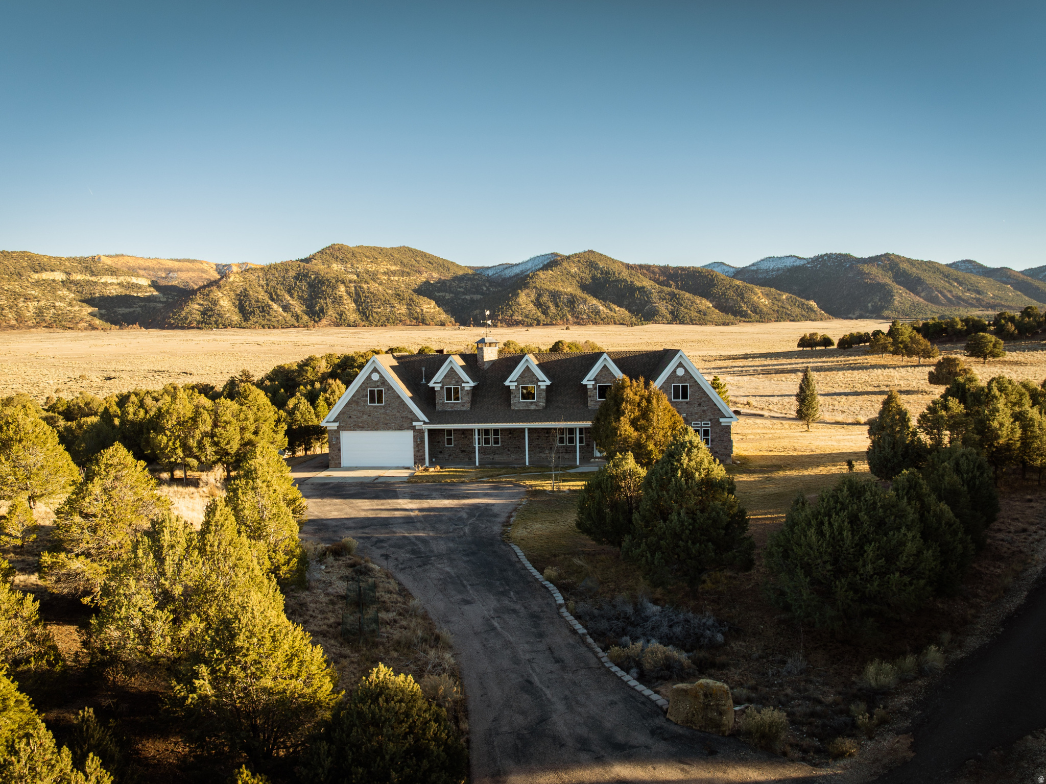 Water is everything in Southern Utah, and this property delivers in a way that is incredibly rare. Included are 37.827 acre-feet of valuable water rights, along with a private well and multiple water access points throughout the land. Combined with ~88 acres of usable, rolling terrain, this creates a level of flexibility, control, and long-term value that is nearly impossible to replicate. Set in the wide-open landscape of Hatch, this luxury ranch offers unrestricted ownership with no HOA and no CC&Rs, allowing you to truly use the land how you want. The acreage is already set up for function and expansion, featuring established fencing and corrals, irrigated ground ready for agricultural use or a greenhouse, and endless space for livestock, recreation, or future improvements. At the center of the property sits a 7,010 sq ft custom-built home, fully finished across three levels. Designed to complement the land, the home features rich custom woodwork, high-end finishes, and a walk-out basement that opens directly to the surrounding views. A geothermal system and updated infrastructure provide efficient, long-term livability, while expansive outdoor spaces including a Trex deck and large patio create a seamless connection to the landscape. The property also includes a 1,024 sq ft guest apartment above the shop, complete with two bedrooms, full kitchen, living space, private deck, and its own septic system. Ideal for guests, caretakers, or multi-generational use. The ~3,000 sq ft shop and garage is built for serious utility, offering large clearances, multiple bays, full wiring, its own pump and septic, and space for equipment, vehicles, or recreational storage. Located within 45 minutes of Bryce Canyon, Zion National Park, Cedar Breaks, Brian Head, and Panguitch Lake, the property sits in one of Utah's most sought-after recreation corridors, with direct access to ATV trails, hunting, fishing, and year-round outdoor use. Despite the privacy, the home and shop are equipped with gigabit internet, making full-time living or remote work effortless. Additional features include two full RV hookups, approximately one acre of manicured lawn, subdivision water access if desired, and the ability to add additional structures or homes. Furniture and equipment may also be included. This is a rare opportunity to own high-acreage land with significant water rights in Southern Utah, paired with a fully improved luxury ranch setup. Properties with this combination of water, land, infrastructure, and location are extremely limited and difficult to replace.