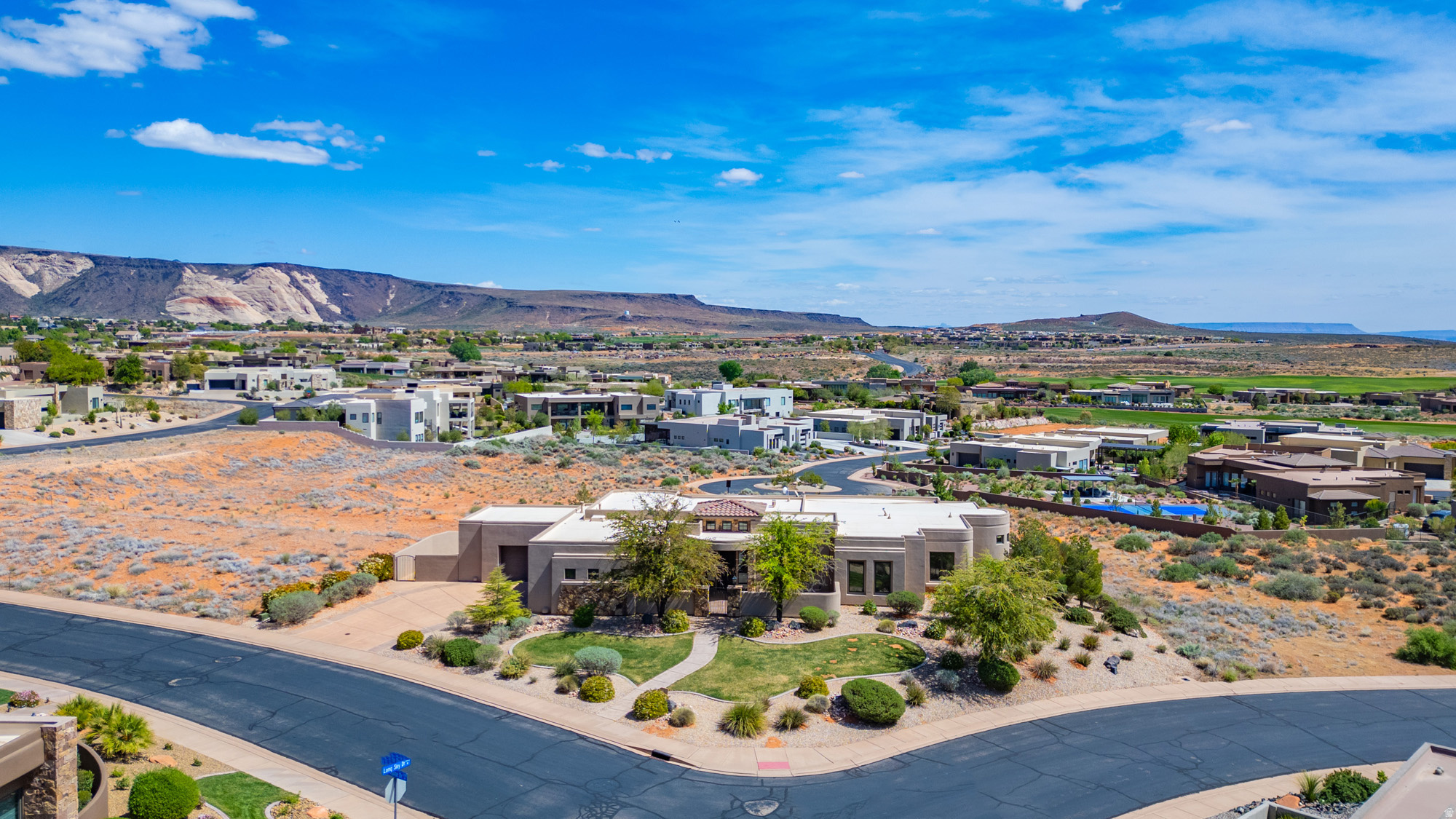Exceptional luxury estate located in the prestigious gated community of The Ledges, offering breathtaking 360-degree red rock and mountain views. Perfectly positioned on a premier corner lot, this remarkable home features an inviting front courtyard, patios, and expansive decks designed to maximize indoor-outdoor living and showcase the spectacular Southern Utah surroundings.  The open-concept floor plan is filled with natural light and offers spacious living areas ideal for both entertaining and everyday comfort. The expansive main-level primary suite serves as a private retreat and includes a cozy sitting room, perfect for relaxing and enjoying the views.  The beautifully landscaped backyard creates a private park-like setting with no visible neighbors and features a private pool, providing the ultimate in privacy, tranquility, and outdoor enjoyment.  The walk-out basement offers exceptional flexibility for multi-generational living, a guest suite, or private living quarters, complete with a large family room, partial kitchen, spacious bedroom, full bathroom, abundant storage, and direct outdoor access.  A rare opportunity to own a truly one-of-a-kind luxury home with private pool, panoramic views, and separate living space in one of St. George's most sought-after communities.