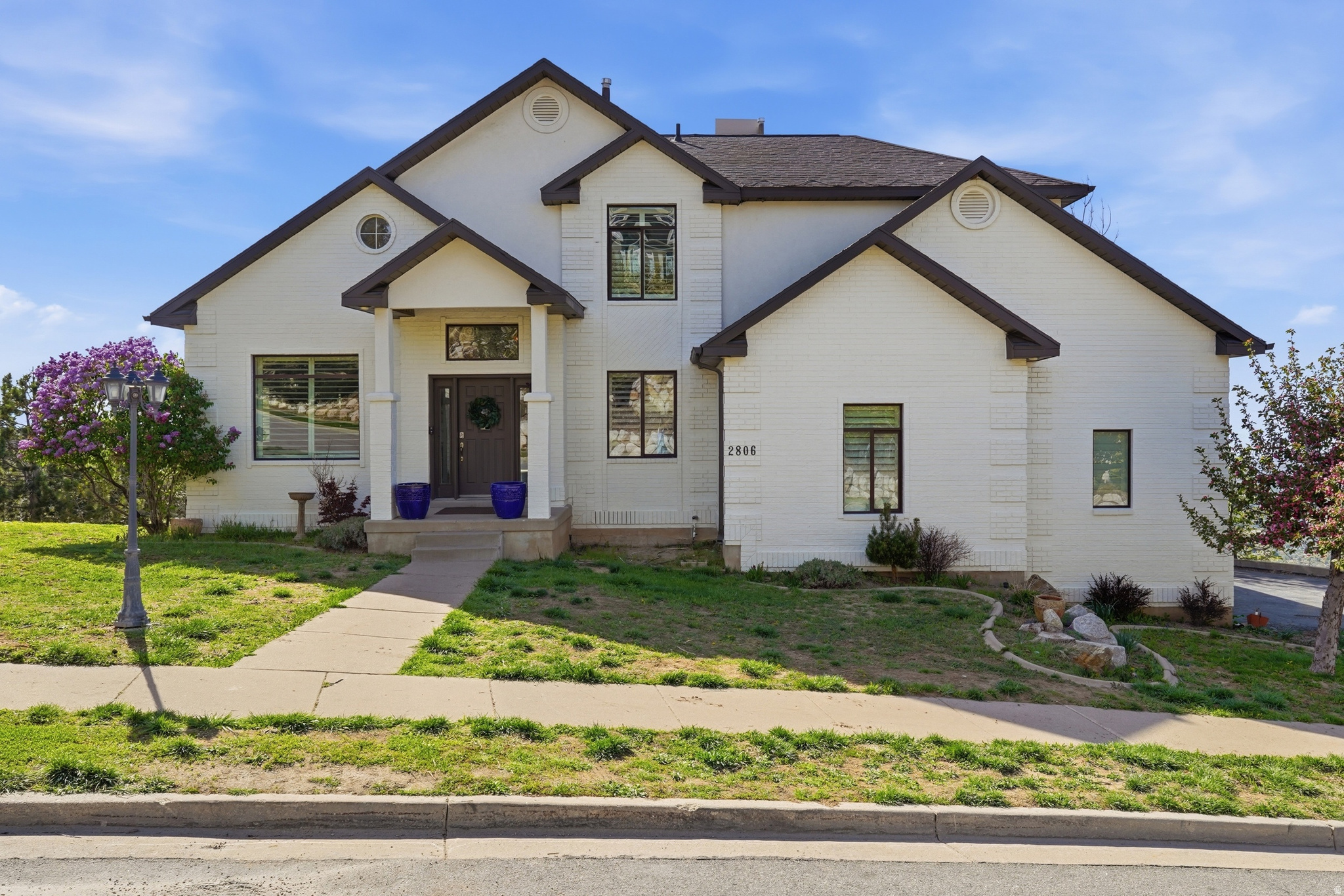 SOFT OPEN HOUSE Saturday 6/6 10-11:30 am **PRICE IMPROVEMENT**Million dollar VIEWS! VIEWS! VIEWS!** Perched at the very top of coveted Maple Hills on the Bountiful Bench, this exceptional four-story home captures some of the most breathtaking, unobstructed views in all of Davis County- stretching from Antelope Island across the Great Salt Lake and the entire valley below. Set on a private street and nestled on a beautifully terraced .62-acre lot, the property blends natural landscape with manicured spaces, creating a peaceful retreat that feels worlds away.  Spanning over 4,500 square feet, the home is designed to maximize both space and scenery. The back side of the home faces the valley and is lined with expansive windows and multiple decks on every level, ensuring the views are always front and center. Inside, vaulted ceilings and a dramatic two-story entry create an immediate sense of scale and light, complemented by formal living, dining room, and great room spaces ideal for both everyday living and entertaining.  The gourmet kitchen anchors the main level, flowing seamlessly into gathering spaces warmed by a striking double-sided fireplace. The primary suite offers a private escape, complete with a spa-like steam shower designed for relaxation and another double-sided fireplace, and its own private deck.  With four bedrooms and four bathrooms, this home also delivers rare lifestyle amenities, including an indoor full-size sports court and a dedicated theater room-bringing recreation and entertainment right into your daily routine.  Combining privacy, elevation, and unmatched panoramic views, this is a rare opportunity to own one of the most scenic vantage points on the Bountiful Bench.