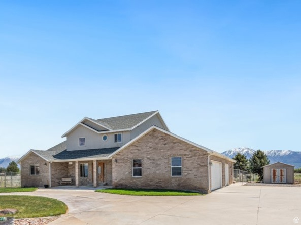 Experience the perfect blend of country living and functionality on this exceptional 6.35-acre property in Benjamin, Utah.  Featuring a classic brick home offering a beautiful serene space with true rural appeal.  Designed with horse owners in mind, the land is equipped with durable steel fencing, creating secure and well-defined areas for animals to roam safely. The property benefits from an established irrigation water supply from Strawberry water, providing the resources needed to maintain pasture, support livestock, and keep the land productive throughout the seasons.   A standout feature is the massive workshop/garage-ideal for mechanics, hobbyists, or anyone needing room to work on vehicles, farm equipment or large projects. This versatile space adds significant functionality and value.  Enjoy wide-open views, peaceful surroundings, and the opportunity to create your ideal country lifestyle-all while being conveniently located within easy reach of town amenities. . Buyer is responsible to verify all listing information, including square feet/acreage, to buyer's own satisfaction.