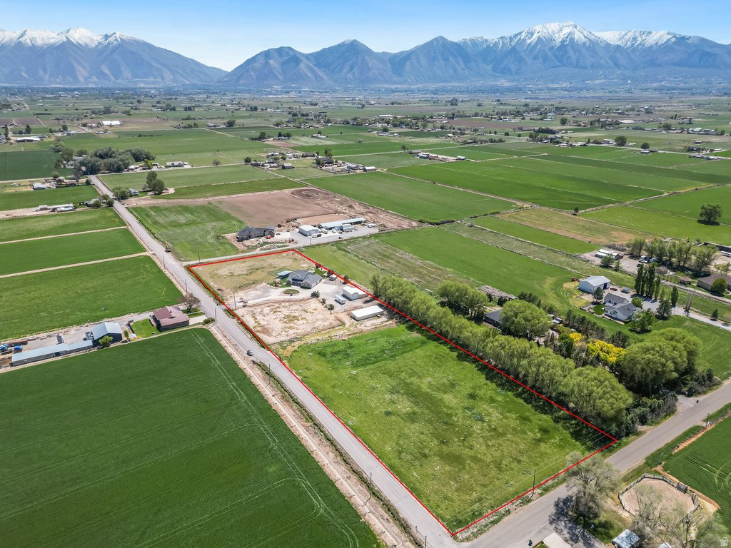 Experience the perfect blend of country living and functionality on this exceptional 6.35-acre property in Benjamin, Utah.  Featuring a classic brick home, full of character, offering a beautiful serene space with true rural appeal.  Designed with horse owners in mind, the land is equipped with durable steel fencing, creating secure and well-defined areas for animals to roam safely. The property benefits from an established irrigation water supply, providing the resources needed to maintain pasture, support livestock, and keep the land productive throughout the seasons.   A standout feature is the massive workshop/garage-ideal for mechanics, hobbyists, or anyone needing room to work on vehicles, farm equipment or large projects. This versatile space adds significant functionality and value.  Enjoy wide-open views, peaceful surroundings, and the opportunity to create your ideal country lifestyle-all while being conveniently located within easy reach of town amenities.