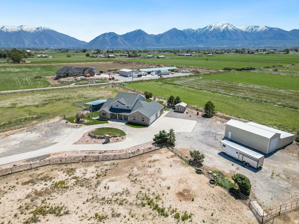 HORSE PROPERTY! Experience the perfect blend of country living and functionality on this exceptional 6.35-acre property in Benjamin, Utah.  Featuring a classic brick home offering a beautiful serene space with true rural appeal.  Designed with horse owners in mind, the land is equipped with durable steel fencing, creating secure and well-defined areas for animals to roam safely. The property benefits from an established irrigation water supply from Strawberry water, providing the resources needed to maintain pasture, support livestock, and keep the land productive throughout the seasons.   A standout feature is the massive workshop/garage-ideal for mechanics, hobbyists, or anyone needing room to work on vehicles, farm equipment or large projects. This versatile space adds significant functionality and value.  Enjoy wide-open views, peaceful surroundings, and the opportunity to create your ideal country lifestyle-all while being conveniently located within easy reach of town amenities. . Buyer is responsible to verify all listing information, including square feet/acreage, to buyer's own satisfaction.
