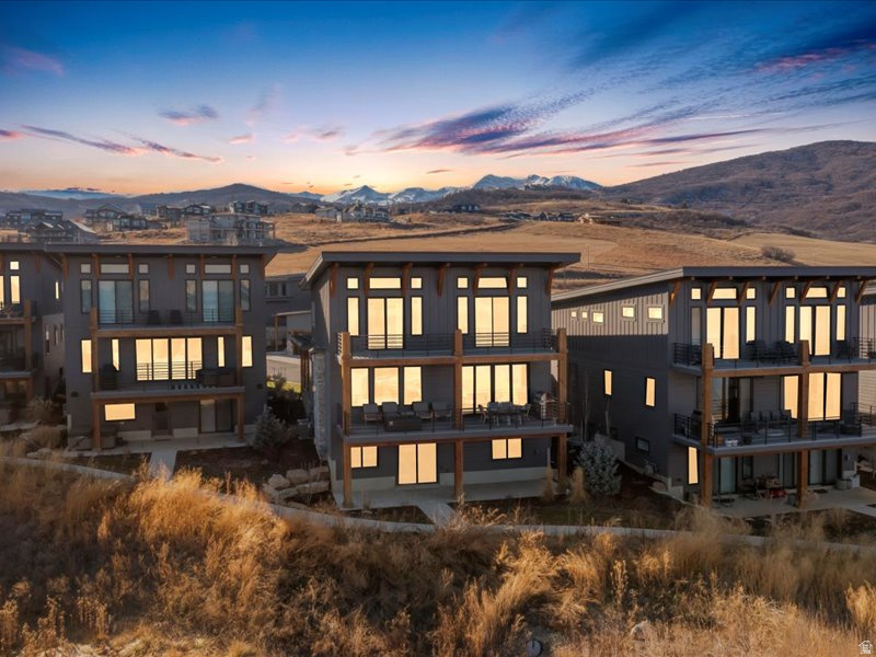 This lakefront home in The Escapes at Edgewater offers rare direct water views over Pineview Reservoir with the added benefit of short term rental zoning, blending lifestyle appeal with strong income potential. Featuring hardwood floors throughout, a chef focused kitchen with upgraded appliances including a premium range and built in refrigerator, quartzite countertops, and a prep sink ideal for entertaining. The primary suite is finished with marble countertops. The secondary baths and powder room features quartz for a cohesive look. Ensuite bathrooms for all upper level suites and a jack and jill bathroom for the lower level. Upgraded cabinetry adds storage and polish throughout the home. An integrated sound system serves the main level, basement media room, and outdoor deck. Enhanced floor and wall insulation improves year round comfort and sound management. It includes custom drapery in select upstairs bedrooms and the landing pairs with motorized shades throughout. Cozy up to two stone fireplaces anchoring the living spaces. With a closed in loft providing a dedicated office area. Enjoy the oversized sliding doors off the dining area, designed to maximize lake views.  Practical upgrades include a water softener, roof heat cable, epoxy coated garage floors, dual tankless water heaters, and electrical in place on the lower patio for a future hot tub. All located just 8 minutes to world class skiing at Snowbasin Ski Resort, home to the 2034 Winter Olympics, and 25 minutes to Powder Mountain Ski Resort. Square footage figures are provided as a courtesy estimate only and were obtained from floor plans. Buyer is advised to obtain an independent measurement.