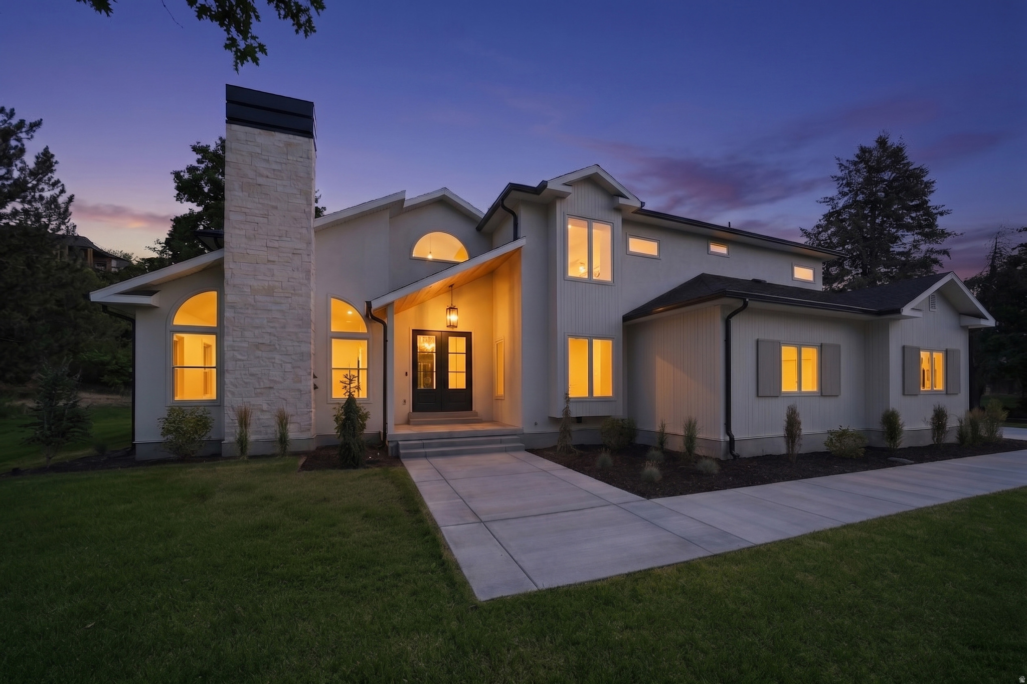 Tucked away on one of the most private and hard to come by lanes in Cottonwood Heights/Sandy area, this fully renovated luxury estate off of Creek Road offers a rare combination of seclusion, sophistication, and convenience. Arrive home by driving through mature trees, panoramic mountain view's, then crossing a picturesque bridge over the creek bed, and entering an exceptionally private setting designed to feel worlds away from the city but still only minutes from golf courses, schools, restaurants and world class skiing as well as only 20 minutes away from downtown and  the SLC airport. This property is perfectly settled up against the hillside with no rear neighbors and strategically positioned to eliminate sightlines to any side neighboring homes creating your own oasis. Inside, no detail has been overlooked. The stunning custom kitchen was thoughtfully designed for both entertaining and everyday living, featuring included premium stainless appliances, a huge custom refrigerator, gas range, double Dutch ovens, abundant custom cabinetry, and a full wraparound butler's pantry with large windows creating beautiful backyard views and exceptional storage space. Luxury finishes continue throughout the home with all new plumbing fixtures, sinks, designer tile work, and beautifully remodeled bathrooms. Enjoy immersive surround sound speakers throughout the entire home, including the basement theatre room and kitchen. The spacious primary retreat offers its own private walkout deck, large enough for outdoor furniture and the perfect place to unwind while enjoying the peaceful surroundings and mountain side views. The walkout basement provides additional living and entertaining space with direct backyard access as well. Outside, the grounds offer endless possibilities with ample room for a future pool, pickleball court, or additional outdoor amenities. The completely redone walkout patio deck is perfectly positioned to enjoy evening shade year round. Recent upgrades include a new roof, HVAC system, water heater, electrical system, automatic sprinkler system, concrete driveway, designer garage doors, and epoxy coated flooring in the oversized extra length 3 potentially 4 car garage with an EV hookup and RV parking. This is a truly turnkey luxury property where every major system and finish has been thoughtfully updated, creating a one of a kind private retreat in one of Sandy's most desirable locations. Homes in this neighborhood don't come around often, schedule your tour today!
