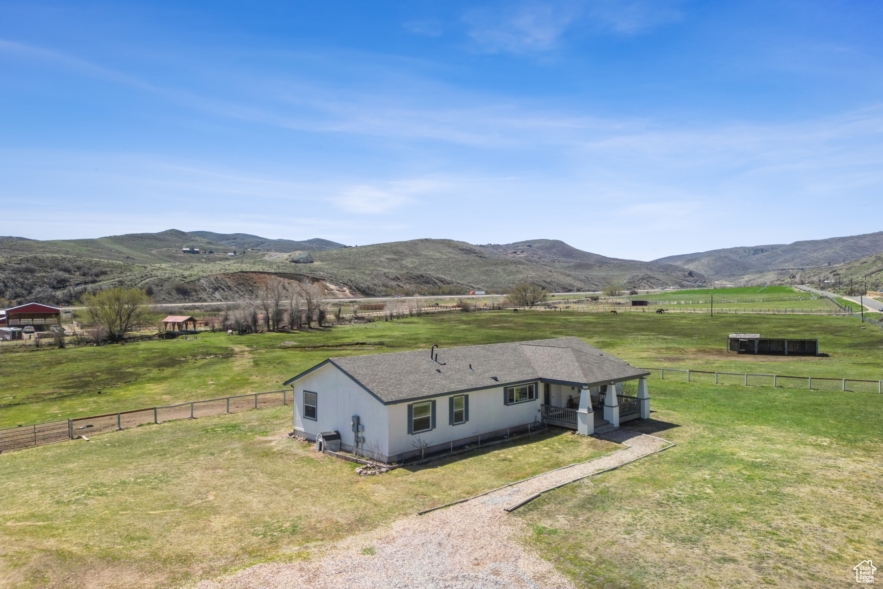 Make your horses' dreams come true! Custom manufactured home on 9 acres waterfront pasture. Only 4 minutes to the High West Distillery and Lodge at Blue Sky. 20 minutes to Park City's world class ski resorts. Turn-key for horses. This property features lush pastures, a red-covered bridge over Silver Creek, and direct access to the rail trail for miles of horseback riding. The 3-bedroom, 2-bath home boasts 1,756 sq. ft., a spacious master suite, and a large covered porch. With 1-acre-foot water right to a private well, 3 shares of pressurized irrigation, and a well-maintained garage/shop with custom horse stalls, this estate is perfect for equestrian enthusiasts. The property includes well-maintained infrastructure, including a fire suppression system, new carpet and paint, and recent upgrades to the well and septic. With easy access to I-80, Salt Lake City, and the airport, this is an ideal opportunity for anyone looking to experience the best of mountain living. Sellers moving to Oregon and will consider all reasonable offers. Check out the video tour of this stunning property!