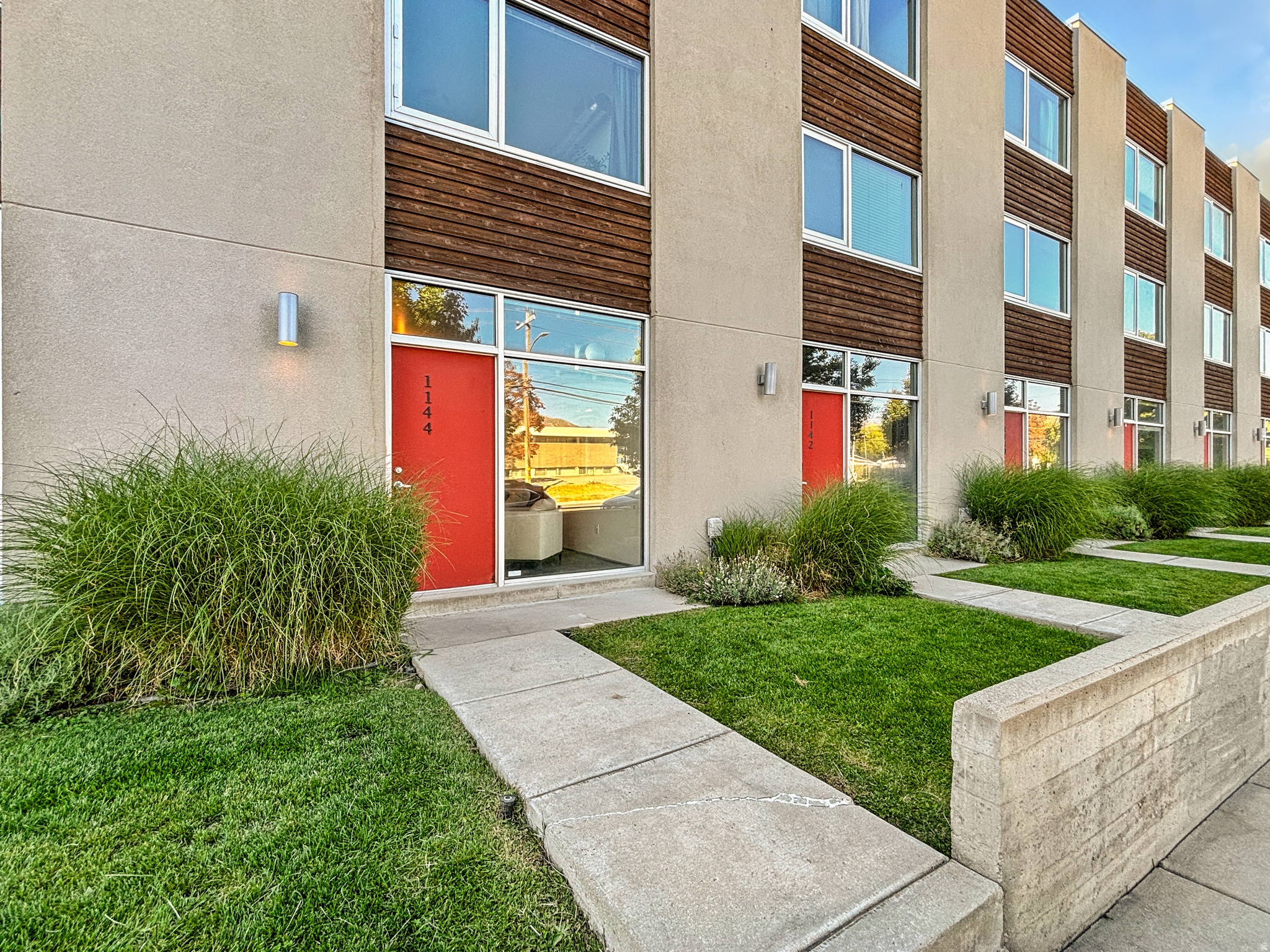 Discover this architectural gem in the vibrant Ballpark district-an urban sanctuary that blends sleek modern design with the energy of city living. Built in 2007 with sophistication in mind, this residence offers an effortless balance of elegance, comfort, and convenience. As you step inside, you're greeted by floor-to-ceiling windows stretching from front to back, bathing the open-concept living, dining, and kitchen areas in natural light. The gourmet kitchen is a true showpiece, featuring high-end finishes, stainless steel appliances, and an expansive layout designed for both entertaining and everyday ease. A stylish half bath on the main level ensures convenience for your guests. Upstairs, two spacious bedrooms and a beautifully appointed bath create a perfect retreat. The third floor is reserved for your private sanctuary-the luxurious primary suite-complete with a walk-in closet, spa-inspired en suite, and a versatile den or office space ideal for work or relaxation. Step outside to a meticulously maintained patio and garden oasis, where you can unwind or host intimate gatherings. With a private two-car garage, your home is not only elegant but functional. Just minutes away, enjoy world-class dining, lively nightlife, boutique shopping, downtown attractions, and easy access to Utah's canyons. Make this a home or your next investment property!! This is more than a home-it's a lifestyle. Don't miss the chance to claim this stunning modern masterpiece before it's gone.
