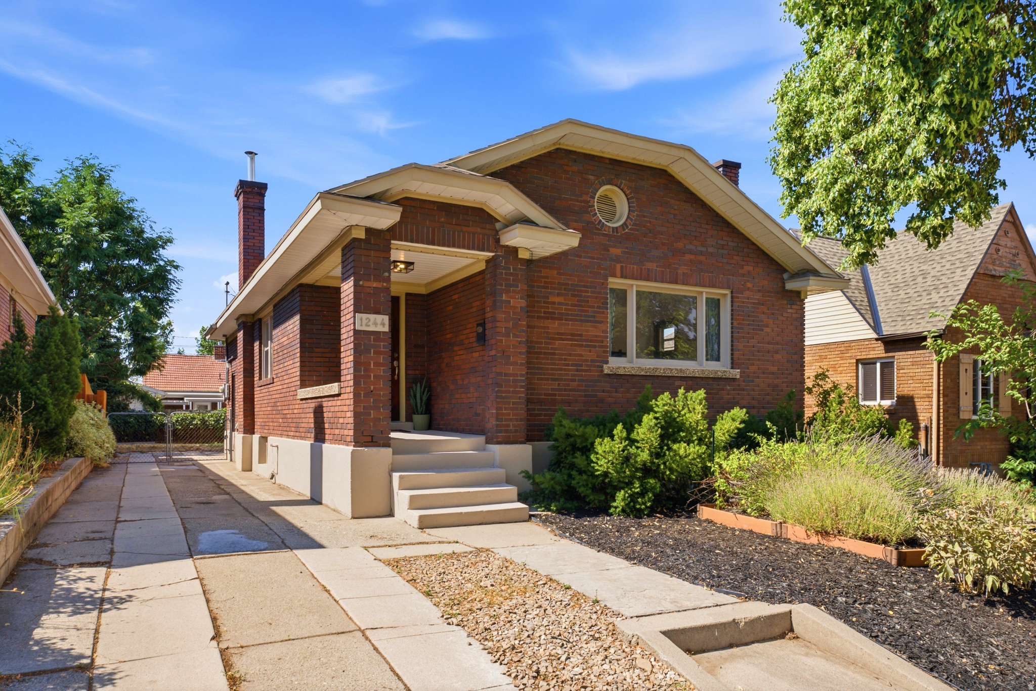 When someone tells you that they're searching for that quintessential Salt Lake City brick bungalow on a quiet tree-lined street, what do you see? Welcome to 1244 E 600 S - a home that isn't just a great address, but one that retains the original character and solid construction of a 1920s build, with the backdrop of an established neighborhood. A charming porch leads you into a quaint entryway, opening up to a large living area with doors, windows, and built-ins framed by the original gum wood trim. Speaking of original, look down - the original hardwoods carry through to a dedicated dining room, with serving made easy with the adjacent breakfast bar and open kitchen just a few steps away. A refreshed full bathroom and two guest bedrooms round out the main level, with a unique opportunity presented on the lower level. Surprise - a separate apartment appointed with laundry, kitchen, a bedroom and living space, plus a full bathroom. Whether you're looking for a home set up for multigenerational living or one that would be an immediate income-producing investment, you found it. Plenty of street and driveway parking that leads to a covered patio out back, so entertaining would be a breeze. With close proximity to walk to the thriving 9th and 9th district or catch a class and a football game at the University of Utah, you simply can't beat the location! Go ahead and try to, I dare you.