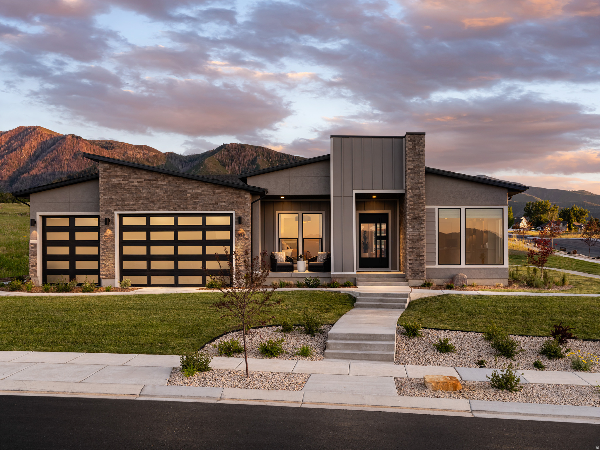 Model Home - A statement of modern luxury set against the breathtaking backdrop of Elk Ridge's foothills. Designed to capture panoramic mountain and valley views from nearly every angle, this exceptional Toll Brothers residence blends architectural sophistication with effortless indoor-outdoor living. Soaring ceilings, expansive walls of glass, designer finishes, and thoughtfully curated living spaces create an atmosphere that is both refined and welcoming. From the private main-level owner's retreat to the resort-inspired outdoor spaces featuring a tranquil water feature and sweeping vistas, every detail has been crafted to elevate daily living. Offering nearly 5,800 square feet of luxury, a dedicated office, theater room, walkout lower level, and a premier .617-acre homesite, this is more than a home-it's a destination.