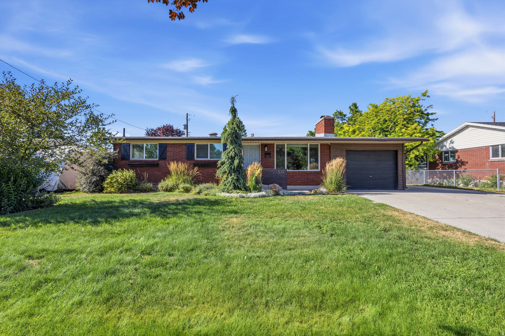 Welcome to this beautifully updated home in the heart of Murray, offering the perfect combination of charm, modern updates, and an unbeatable location. Just  mile from I-215, two blocks from Fashion Place Mall, less than a mile from Wheeler Farm, 1.5 miles to the TRAX station, and only minutes from Big Cottonwood Canyon, you'll enjoy quick access to shopping, dining, recreation, and some of Utah's best outdoor adventures. Located within highly rated Murray schools.   Inside, you'll find timeless character paired with thoughtful updates throughout. The inviting living room features original oak hardwood floors, a striking paneled accent wall, and a beautiful rock fireplace. The updated galley kitchen is designed for both style and function with granite countertops, subway tile backsplash, luxury vinyl plank flooring, open shelving, and a peninsula with bar seating. The adjoining dining room showcases elegant wall molding and opens directly to the covered patio, making indoor-outdoor entertaining effortless.   The main level offers three bedrooms with original hardwood flooring, including a spacious primary suite with an attached bathroom. The full hall bathroom features tile flooring, a faux marble tub surround, and custom floating shelves.   Downstairs, the finished basement provides exceptional additional living space with a large family room centered around a cozy brick fireplace, two additional bedrooms with enlarged windows, a full bathroom, a generous food storage room, and an oversized laundry room with abundant storage space and room for a home gym or hobby area.  A Nest thermostat adds modern comfort and energy efficiency.  Step outside to a private, fully fenced backyard featuring mature landscaping, a spacious covered patio, and beautiful views of Mount Olympus. The property also includes a detached 200-square-foot storage shed, an attached single-car garage with an enclosed storage area, and a large concrete RV parking pad with plenty of additional off-street parking.   With nearly every major interior space thoughtfully updated over the past decade, this move-in-ready home offers classic character, functional living spaces, and an outstanding central location that's hard to beat.  All information is provided as a courtesy and should be verified by Buyer.   Square footage figures are provided as a courtesy estimate only and were obtained from county records.  Buyer is advised to obtain an independent measurement.