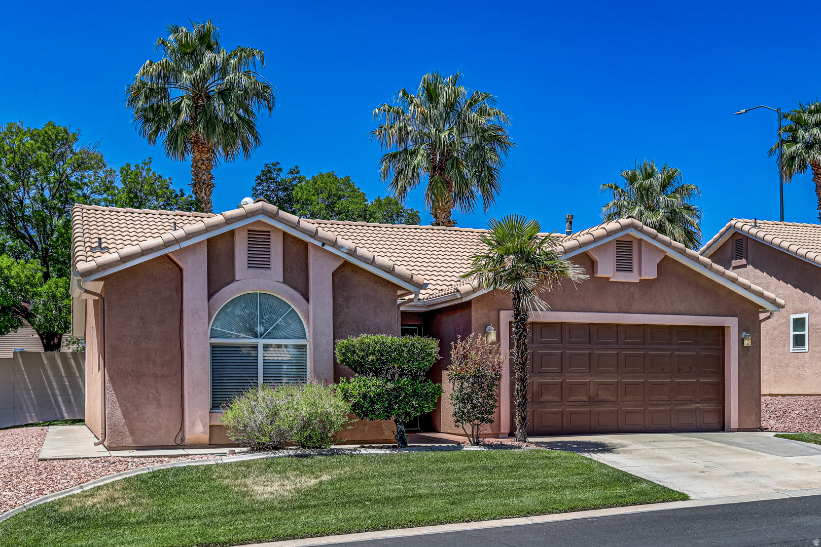 Fully refreshed and move-in ready! Freestanding townhome in the popular 55+ community of Santa Fe at Red Cliffs! This light and bright home features an open floorplan that lives larger than its 1,138 sq. ft., with 2 bedrooms and 2 bathrooms separated by a spacious great room. Recent updates include new LVP flooring, new carpet, fresh paint, newer HVAC system, and water softener. Enjoy a large 2-car garage, spacious covered patio, indoor pool & jacuzzi, beautifully updated clubhouse, and HOA-provided yard maintenance for easy, stress-free living. Convenient Mall Dr location near shopping, dining, medical, entertainment, and I-15.