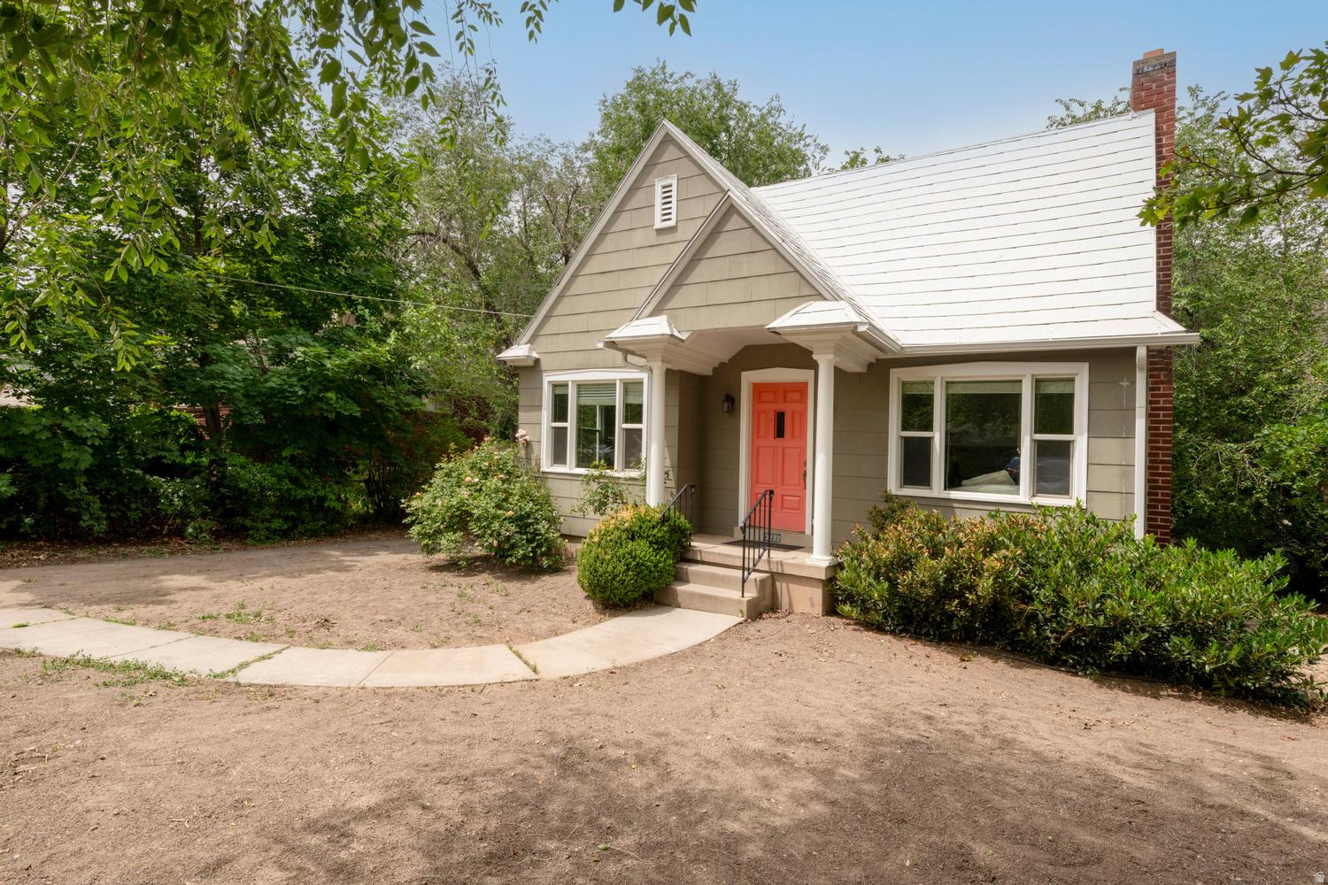 This quaint Tudor cottage sits at the north edge of Millcreek on an unexpectedly quiet street, just a short walk to Millcreek Common, with convenient access to the Sugar House Business District and... the on-ramps to take you across town or out of the valley! Comprehensively remodeled in 2014, the home has a great floor plan with an open & connected kitchen and especially spacious bedrooms with proper egress windows. Downstairs is plumbed for a kitchen - or a dark room ;) and easily set up as a functional, separate living quarters with a lock-out style side entrance. The old world charm of this home has been maintained by preserving the single panel doors with their crystal & brass hardware, the original archways, and real hardwood floors. From this century, you'll find tastefully modern brushed gold light fixtures, double pane insulated windows and updated mechanical systems. Laundry/utility room with ample space. Exercise/sauna room. Bright storage. Clean slate front yard. Oh, the vintage gas fireplace insert - and that laundry chute!