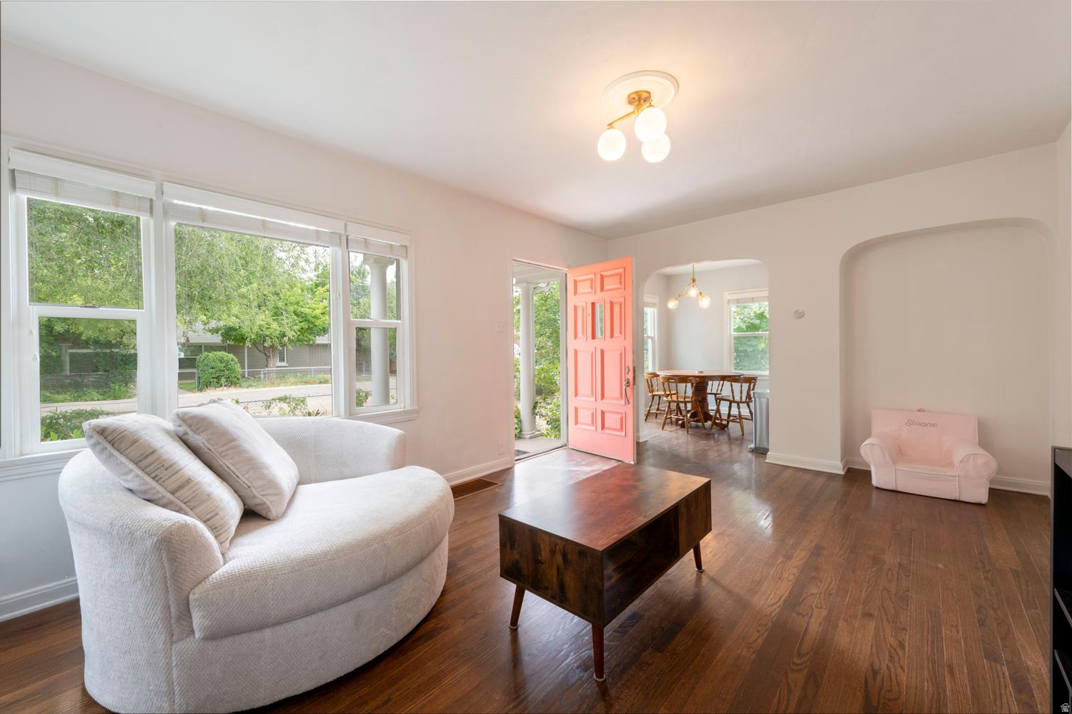 This quaint Tudor cottage sits at the north edge of Millcreek on an unexpectedly quiet street, just a short walk to Millcreek Common, with convenient access to the Sugar House Business District and... the on-ramps to take you across town or out of the valley! Comprehensively remodeled in 2014, the home has a great floor plan with an open & connected kitchen and especially spacious bedrooms with proper egress windows. Downstairs is plumbed for a kitchen - or a dark room ;) and easily set up as a functional, separate living quarters with a lock-out style side entrance. The old world charm of this home has been maintained by preserving the single panel doors with their crystal & brass hardware, the original archways, and real hardwood floors. From this century, you'll find tastefully modern brushed gold light fixtures, double pane insulated windows and updated mechanical systems. Laundry/utility room with ample space. Exercise/sauna room. Bright storage. Clean slate front yard. Oh, the vintage gas fireplace insert - and that laundry chute!