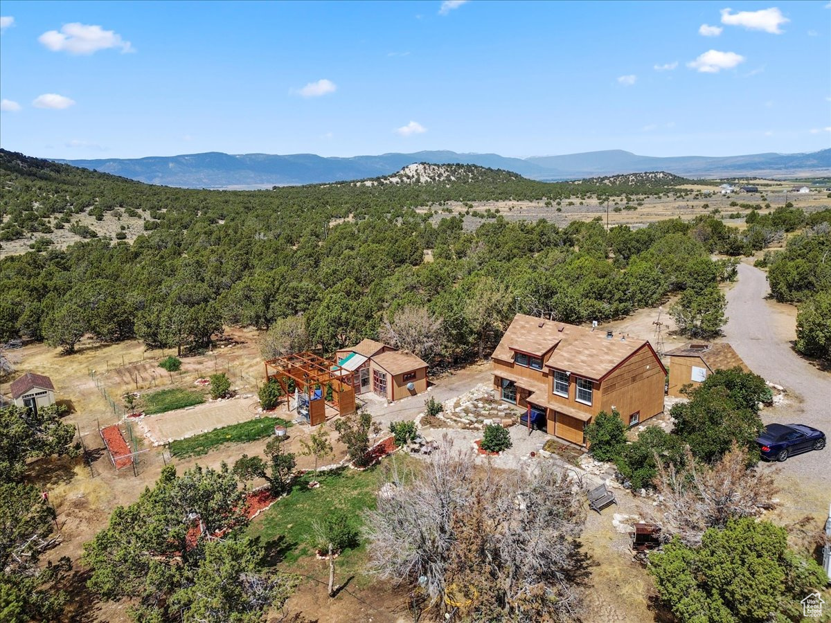 Your horses called, they want to live here.  Don't miss this idyllic hideaway in the heart of Sanpete County. Located just three miles south of historic Spring City, this 15.9 acre property offers peace, privacy, and a true back to the land lifestyle. Surrounded by juniper trees and sweeping mountain views, the home is tucked away with no close neighbors in sight.  This property is one of those rare finds that feels special the moment you arrive. Inside and out, it is full of charm, character, and little details you continue to notice the more you explore. The home has been thoughtfully updated with granite countertops, new cabinetry, and custom touches throughout. A flexible mudroom or bonus room offers space for a home office, extra bedroom, or whatever fits your needs best. Upstairs, you'll find two cozy bedrooms and a full bath, while the pellet stove adds warmth and charm for those cold winter nights.  Step outside and take in the wide open skies, breathtaking sunsets, and the kind of quiet that is hard to find. The cobblestone patio is the perfect place to unwind, while the pergola covered sitting area is ready for BBQs, entertaining, or simply enjoying the view. The property also includes a level sand pad for the included 12' x 22' above ground pool, making summer days easy and fun.  The land is fully fenced and currently set up for horses with 5 foot panels, a canvas style barn, and plenty of room to ride, train, or roam. A private well provides reliable water, and the chicken coop with added storage is included. Multiple exterior sheds offer great space for tools, tack, and equipment. There is also a well maintained garden area ready for planting, along with established fruit trees and grapevines.  Adding even more to its appeal, the property has its own personal weather station, and just across the street you'll find the Wildlife Management Area with miles of trails for horseback riding and endless exploring.  If you've been dreaming of a property with room to breathe, roam, and truly enjoy the beauty of country living, this is the one.