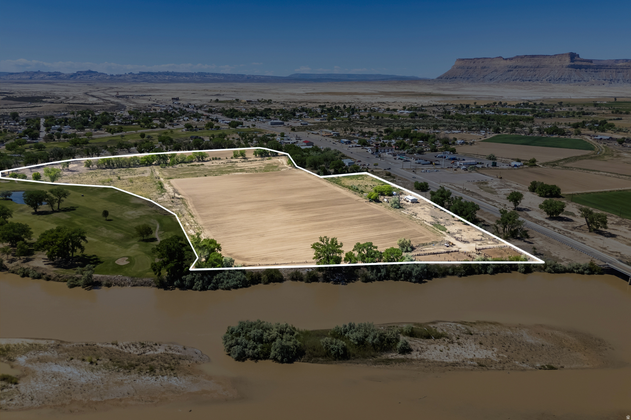 BUILD YOUR DREAM HERE! PRIME MAIN STREET PROPERTY BORDERING BOTH THE GREEN RIVER AND THE GREEN RIVER STATE PARK GOLF COURSE. This rare 45.51-acre property offers a unique opportunity to continue using the land as it is today or transform it into your next development project. Currently used for growing crops and grazing livestock, the property includes 80 water shares and valuable water rights to support agricultural use. In addition to the expansive acreage, the property includes a well-maintained 4-bedroom, 2-bath home, making it ideal for an owner-occupant, farm manager, or rental property. With over 1,170 feet of Main Street frontage and C-1 and R-1 zoning, the possibilities are extensive. Continue operating as productive farmland, enjoy it as a private residence with room to grow, or explore future development opportunities such as residential lots, commercial uses, hospitality, or a potential RV resort with conditional use approval. Bordering both the Green River and the Green River State Park Golf Course, this one-of-a-kind property combines location, flexibility, and investment potential in the heart of Green River. Whether you are looking for a working farm, a legacy property, or a large-scale development opportunity, this property offers the chance to bring your vision to life.