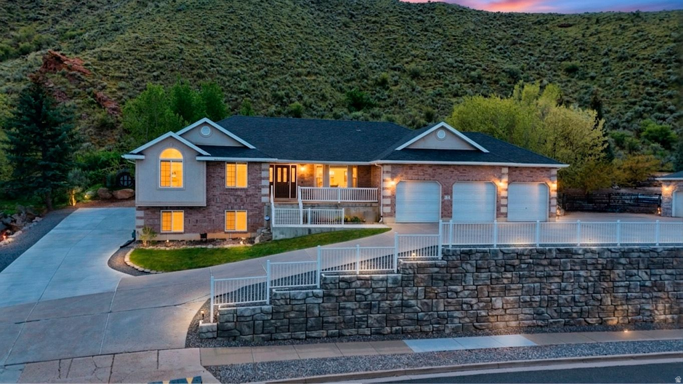 Welcome to your private Morgan Valley retreat on 1.78 acres where your only backyard neighbors are the deer!  This beautifully maintained home offers the perfect blend of modern upgrades, energy independence, and peaceful country living in the heart of Morgan, Utah. With recent mechanical updates and a brand new Accessory Dwelling Unit, this property delivers both comfort and versatility.  Energy Independence & Peace of Mind: Power outages are a thing of the past with the recently installed solar panel system featuring battery backup that keeps your home running when the grid goes down. Combined with a new roof installed in 2019, this home is built for reliability and efficiency.  Recent Mechanical Upgrades: This home has been meticulously maintained with major systems recently updated including two water heaters replaced in 2025, furnace and AC replaced in 2020, and a Kinetico water softener system installed in 2022. Move in with confidence knowing the major systems are taken care of.  Versatile Living Spaces: The newly constructed Accessory Dwelling Unit provides incredible flexibility for rental income potential, multi generational living, or guest accommodations. The main home features an electric fireplace in the upstairs family room and a cozy gas insert downstairs, creating warm gathering spaces throughout.  Unique Features: Discover the hidden door leading to secure storage and a gun vault, providing both functionality and peace of mind for your valuables.  The Setting: Nestled on 1.78 acres of serene hillside property, this home offers the ultimate in privacy and natural beauty. Watch deer graze in your backyard while enjoying stunning mountain views and the tranquility of Morgan Valley living. Close to Morgan City amenities yet far enough to enjoy true peace and quiet.  Prime Location: Situated in Morgan, Utah, this property provides easy access to world class outdoor recreation and a tight knit community atmosphere. Commute to Ogden, Salt Lake City, or Park City while coming home to your private sanctuary.