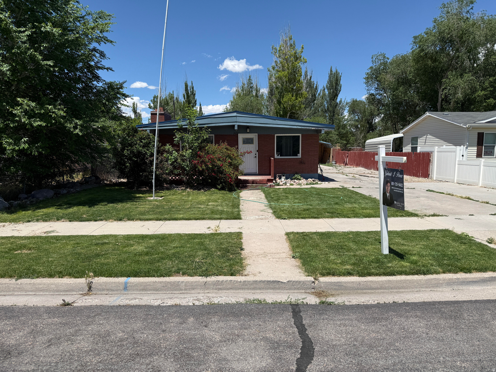 Beautiful brick rambler with a metal roof, updated kitchen, and new carpet to be installed in the living room and basement. Spacious layout with 5 bedrooms, 2 bathrooms, a large basement, primary suite/family room option, jetted tub, separate shower, laundry/storage area, and plenty of parking. Large fenced backyard with detached garage/workshop, covered parking, garden space, and room for RVs, trailers, or toys. Great opportunity with flexible use and no HOA. Buyer to verify all.