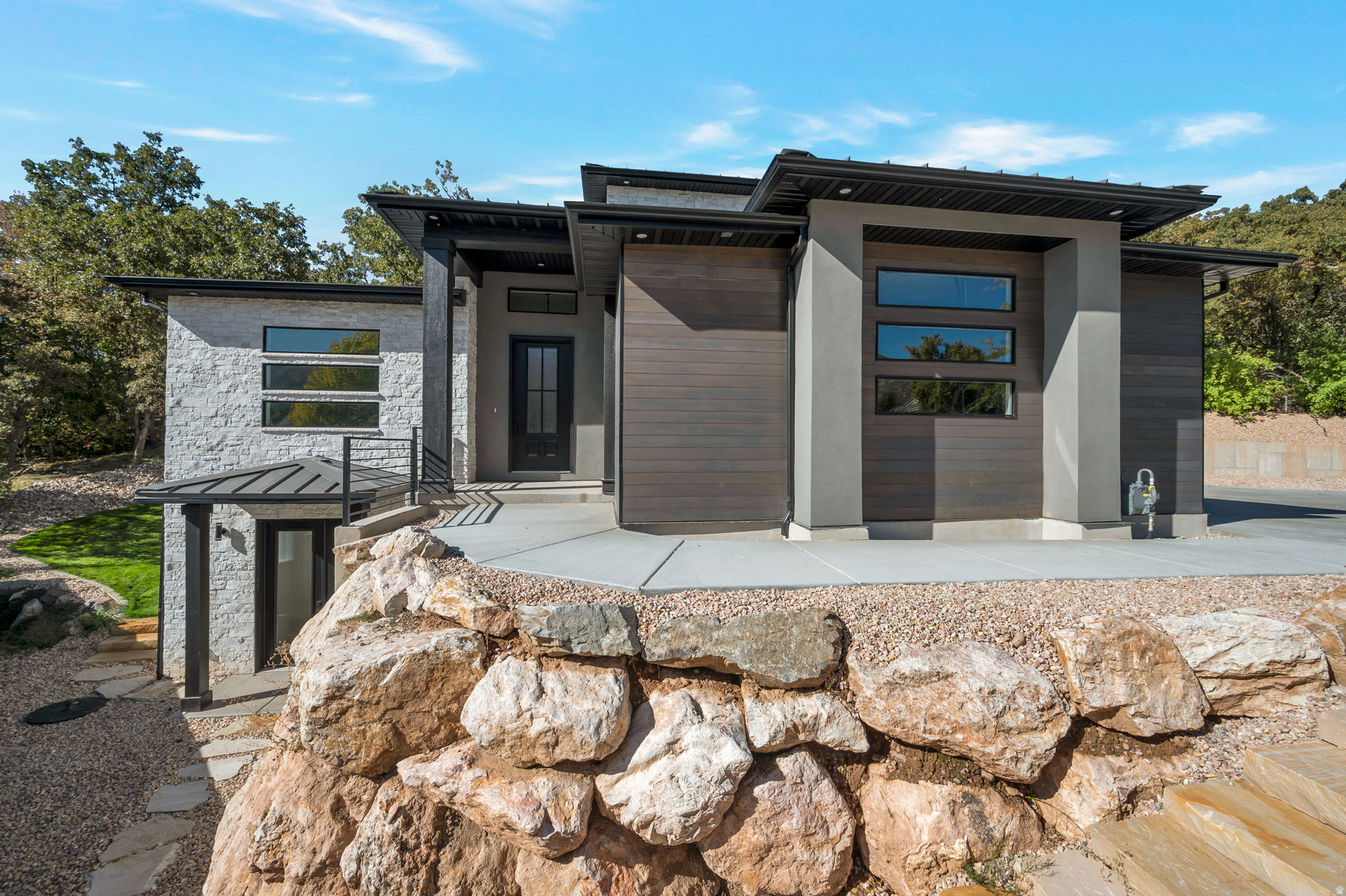 Reduced! Open Saturday 5/23 1:15-3:15! Modern Two Story Home Loaded with Upgrades! This stunning modern home in South Ogden offers a functional layout with stylish finishes throughout. The spacious Great Room flows seamlessly into the Kitchen, where a full window wall and sliding glass doors open to a beautiful outdoor patio-perfect for indoor/outdoor living and entertaining. Enjoy sleek, modern designs, upgraded kitchen finishes, and a large walk-in pantry. The main laundry room is conveniently connected to the mudroom just off the garage.The Master bedroom is a true retreat, featuring a separate tub and shower, plus in-suite laundry hookups located in the large walk-in closet. Downstairs, you'll find a second Primary-like suite with its own walk-in closet and private laundry hookups- ideal for guests or multi-generational living.The lower-level living room includes a kitchenette and two separate entries-one of which is a private entrance perfect for a home office/business or potentially an ADU. Additional highlights: 3-car garage with an extra-deep 3rd bay,RV parking along the side of the garage. Terraced backyard with a lovely patio space, Don't miss your chance to own this feature-rich, move-in-ready modern home!