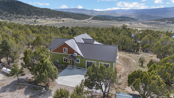 Stunning Hideaway Valley estate on Storm Mountain Rd! This custom home features a main-floor master, vaulted ceilings, and a $26k sound system. The gourmet kitchen boasts charcoal stainless appliances, granite counters, and 10' ceilings. Includes a walkout basement with a full apartment, gym, and secret safety room (pp. 1, 3). The 3,200 sq ft top floor offers a bar and rec area. Outside, enjoy a detached cabin with its own bathroom, 40' shop, barn, chicken coop, and 4 shipping containers on a gravity-fed well system. Incredible views and custom finishes throughout!  Have your agent print off the Property Information Sheet attached to the listing for more detailed information on this amazing property.