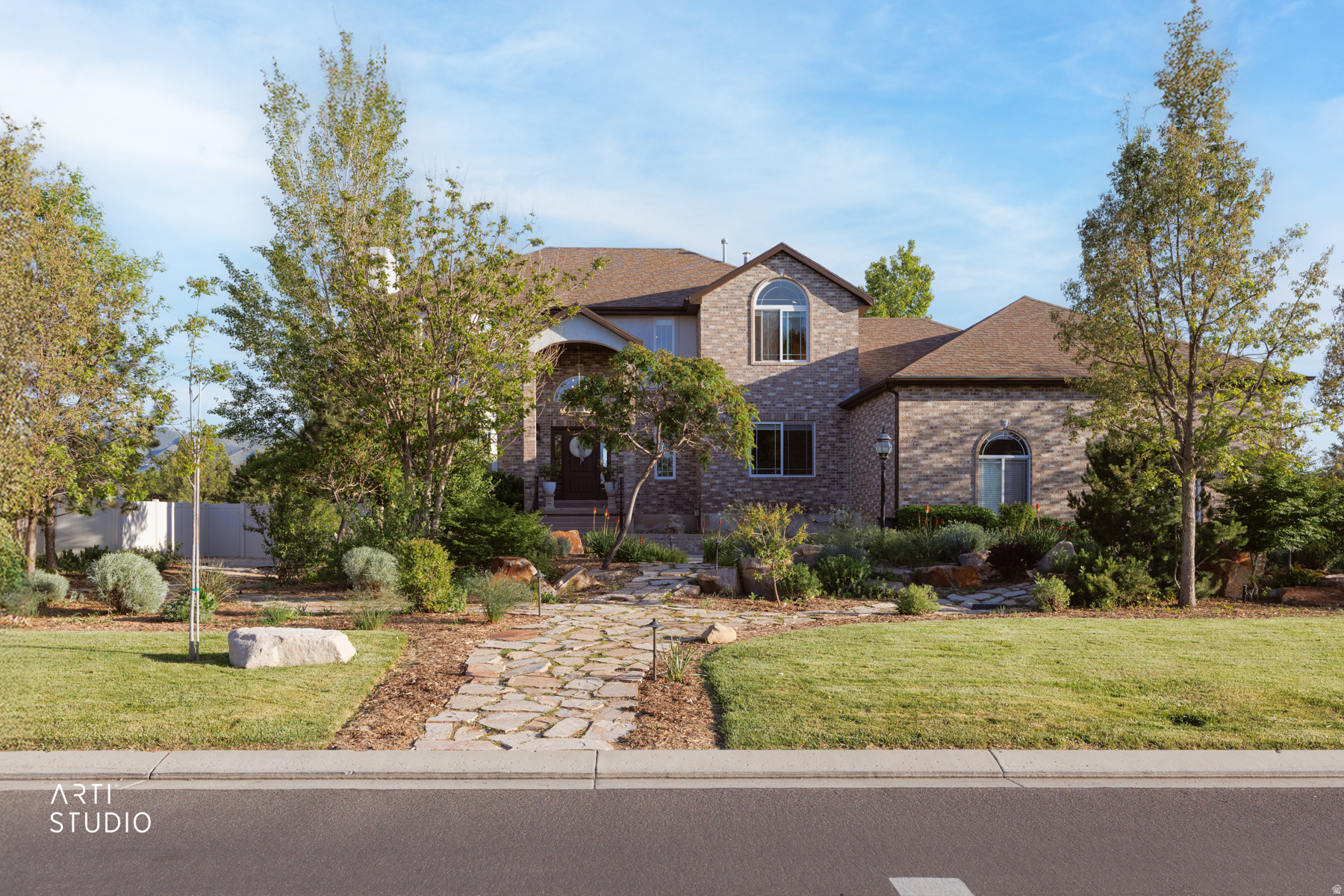Tucked away on a rare 0.99-acre RA1 zoned lot in the heart of Draper, this extraordinary 5,499 sq ft estate blends luxury, comfort, flexibility, and unforgettable outdoor living into one remarkable property. As you arrive, you are immediately welcomed by beautiful private landscaping, gorgeous stone walkways, mature trees, and manicured flower beds that create the feeling of your own secluded retreat. Within minutes to Juan Diego Catholic High School, freeway access, shopping, restaurants, parks, and everyday conveniences, the location perfectly balances peaceful living with city accessibility while placing you within approximately 20 minutes of world-class ski resorts, hiking trails, boating, and Utah's incredible outdoor recreation.     Designed for gathering, entertaining, and creating lifelong memories, this six-bedroom, five-bathroom home offers warmth and functionality throughout every space. The beautifully updated kitchen features granite countertops, premium appliances, abundant cabinetry, and a charming breakfast nook where morning light pours in and conversations linger a little longer. The expansive great room creates the heart of the home with one of three fireplaces anchoring the inviting atmosphere, while oversized windows invite natural light and views into nearly every room.     The main level offers exceptional versatility with a formal dining room, additional living room, spacious home office, large laundry room, and a private bedroom with its own ensuite bath, ideal for guests, multi-generational living, or long-term flexibility.     Upstairs, the expansive primary suite creates a true private retreat with its own cozy fireplace, spacious sitting area, luxurious ensuite bathroom featuring dual sinks, and an oversized walk-in closet designed for both comfort and functionality. Step onto the private balcony and take in breathtaking southern views of the Draper Valley, Salt Lake Valley, and the Wasatch Mountains while enjoying peaceful mornings or relaxing evenings surrounded by Utah's stunning natural beauty.     The fully finished walkout basement was built for entertaining and connection with its own private entrance, wet bar, two large bedrooms, three-quarter bath, and extensive storage space throughout. Whether hosting game nights, holidays, movie marathons, or summer gatherings, this home was designed to be lived in and loved deeply.     Outside, the property transforms into your own private playground featuring two patios, a large deck, sand volleyball court, fenced dog run, storage sheds, a water well pump house with additional storage, and a charming boutique-style chicken coop full of personality. The property also includes valuable secondary water access and an environmentally thoughtful grey water reuse system utilizing laundry water for added efficiency and sustainability. The RA1 zoning allows for livestock and opens endless opportunities for hobby farming, recreation, gardening, or simply enjoying wide-open space rarely found this close to the city. Imagine evenings under the stars, summer volleyball games with friends, backyard gatherings, and quiet mornings surrounded by mountain views and open space.     Adding even more value and efficiency to this impressive estate is Eco-Friendly Features: fully installed and paid-for Grid-Tied 12 kW solar power system, Level 2 EV Charger, Gray water system, 2 whole-house fans and additional layers of attic insulation.  The oversized three-car garage includes an extra-height third bay ideal for RV storage, boats, recreational vehicles, or workshop space. The home is thoughtfully equipped with two furnaces, two whole-house fans, and additional layers of attic insulation designed to enhance year-round comfort, airflow, and overall energy efficiency throughout the property. Combined with the owned solar power system, this home delivers exceptional functionality and cost-conscious living without sacrificing luxury or comfort.     Rarely does a property offer t