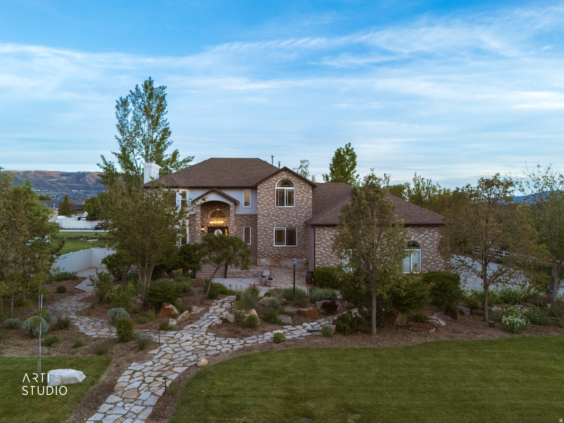 Tucked away on a rare 0.99-acre RA1 zoned lot in the heart of Draper, this extraordinary 5,499 sq ft estate blends luxury, comfort, flexibility, and unforgettable outdoor living into one remarkable property. As you arrive, you are immediately welcomed by beautiful private landscaping, gorgeous stone walkways, mature trees, and manicured flower beds that create the feeling of your own secluded retreat. Within minutes to Juan Diego Catholic High School, freeway access, shopping, restaurants, parks, and everyday conveniences, the location perfectly balances peaceful living with city accessibility while placing you within approximately 20 minutes of world-class ski resorts, hiking trails, boating, and Utah's incredible outdoor recreation.     Designed for gathering, entertaining, and creating lifelong memories, this six-bedroom, five-bathroom home offers warmth and functionality throughout every space. The beautifully updated kitchen features granite countertops, premium appliances, abundant cabinetry, and a charming breakfast nook where morning light pours in and conversations linger a little longer. The expansive great room creates the heart of the home with one of three fireplaces anchoring the inviting atmosphere, while oversized windows invite natural light and views into nearly every room.     The main level offers exceptional versatility with a formal dining room, additional living room, spacious home office, large laundry room, and a private bedroom with its own ensuite bath, ideal for guests, multi-generational living, or long-term flexibility.     Upstairs, the expansive primary suite creates a true private retreat with its own cozy fireplace, spacious sitting area, luxurious ensuite bathroom featuring dual sinks, and an oversized walk-in closet designed for both comfort and functionality. Step onto the private balcony and take in breathtaking southern views of the Draper Valley, Salt Lake Valley, and the Wasatch Mountains while enjoying peaceful mornings or relaxing evenings surrounded by Utah's stunning natural beauty.     The fully finished walkout basement was built for entertaining and connection with its own private entrance, wet bar, two large bedrooms, three-quarter bath, and extensive storage space throughout. Whether hosting game nights, holidays, movie marathons, or summer gatherings, this home was designed to be lived in and loved deeply.     Outside, the property transforms into your own private playground featuring two patios, a large deck, sand volleyball court, fenced dog run, storage sheds, a water well pump house with additional storage, and a charming boutique-style chicken coop full of personality. The property also includes valuable secondary water access and an environmentally thoughtful grey water reuse system utilizing laundry water for added efficiency and sustainability. The RA1 zoning allows for livestock and opens endless opportunities for hobby farming, recreation, gardening, or simply enjoying wide-open space rarely found this close to the city. Imagine evenings under the stars, summer volleyball games with friends, backyard gatherings, and quiet mornings surrounded by mountain views and open space.     Adding even more value and efficiency to this impressive estate is the fully installed and paid-for 12 kWh rooftop solar power system, helping significantly offset utility costs while providing long-term energy savings and efficiency. For a home of this size, the benefit of an owned solar system offers exceptional cost effectiveness and peace of mind, allowing you to enjoy comfortable year-round living with greater energy efficiency and reduced monthly utility expenses.     The oversized three-car garage includes an extra-height third bay ideal for RV storage, boats, recreational vehicles, or workshop space. The home is thoughtfully equipped with two furnaces, two whole-house fans, and additional layers of attic insulation designed to enhance year-round comfort, airflow, and overall energy ef