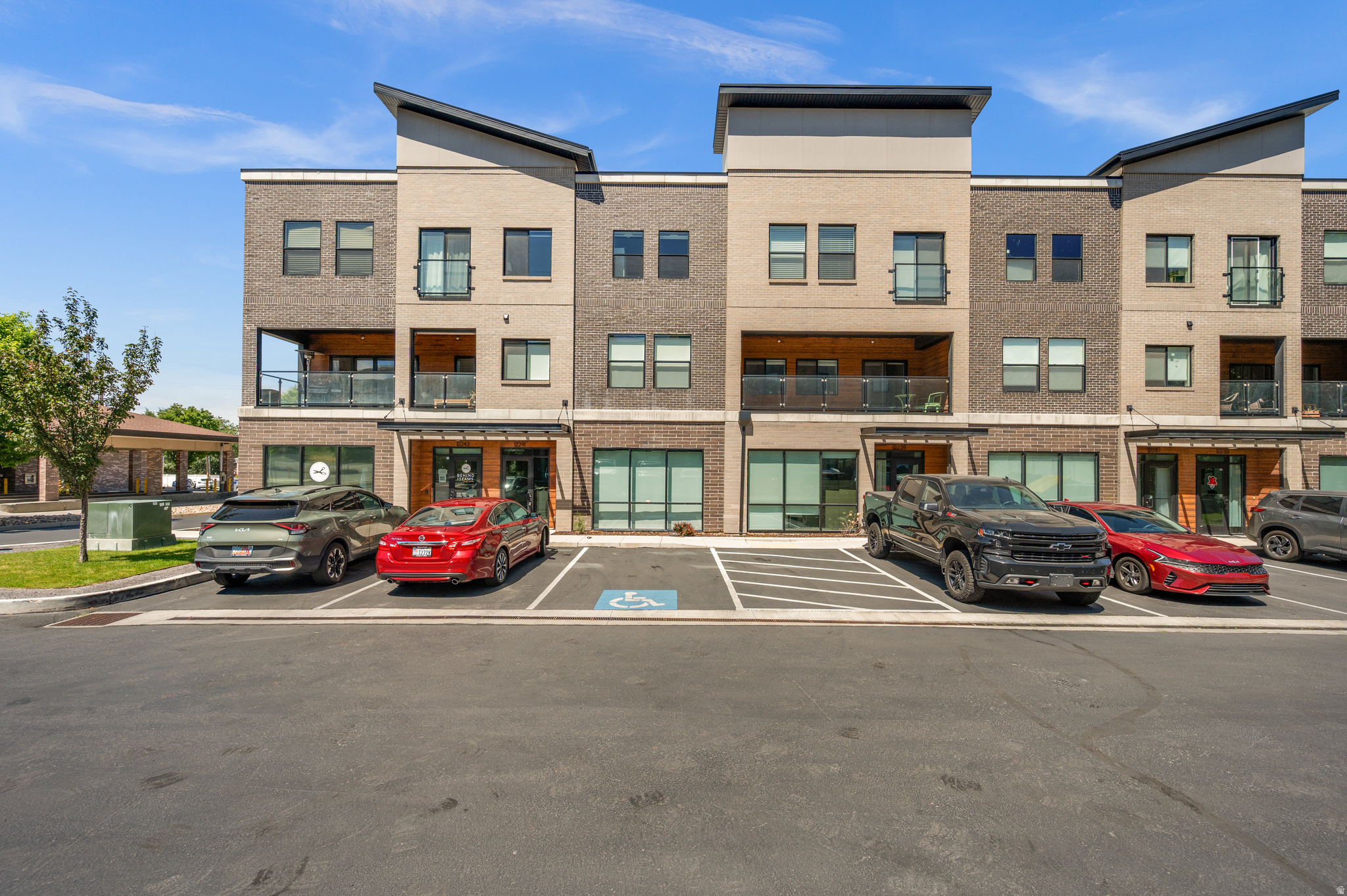Work downstairs. Live upstairs. Build the life you actually want. One of only 15 in an exclusive, live/work development, this stunning Draper townhome is a rare find. The fully commercial-grade ground floor (approx. 600 sq ft) features an ADA-compliant bathroom, glass store-front windows, customer parking, and a private lockout entry ideal for a boutique office, studio, salon, therapy practice, or any client-facing business. Above the commercial suite, the residence delivers the lifestyle to match. High ceilings and premium finishes set the tone throughout, while custom built-ins, designer lighting, and motorized window shades on every window speak to a level of craftsmanship rarely found at this price point. The kitchen opens to a covered patio, perfect for morning coffee or an evening wind-down, and the 2-car attached garage adds everyday convenience. With 3 spacious bedrooms and thoughtful details at every turn, including a tankless water heater for on-demand efficiency, this home is as functional as it is beautiful.