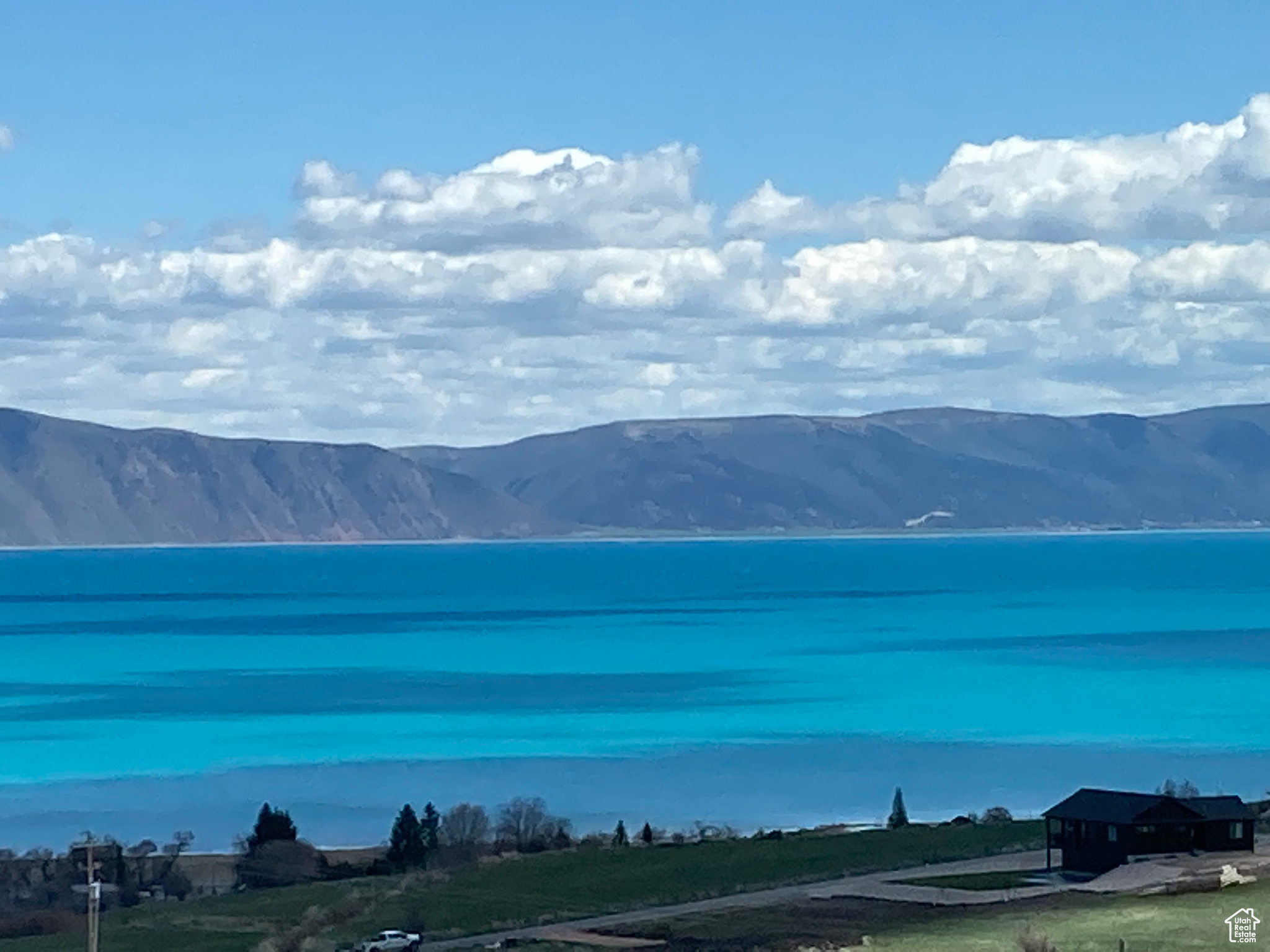 NEW PRICE!!! Motivated seller! Unobstructed views of Bear Lake from this spacious 6 bedroom, 3 bath home. Kitchen has stainless steel appliances, solid surface countertops and an eating bar and is open to a vaulted great room, dining area and a large deck----all with views!  Main floor has master suite plus 2 other bedrooms.  Lower level has 2 additional bedrooms plus a MIL suite with a kitchen. Lots of parking and a two car garage with epoxy floor. House and garage are plumbed for radiant in-floor heat.  Boiler will need installed. Nightly rentals allowed. Sold mostly furnished. Great investment property or personal residence!  Square footage figures are provided as a courtesy estimate only and were obtained from county records.  Buyer is advised to obtain an independent measurement.