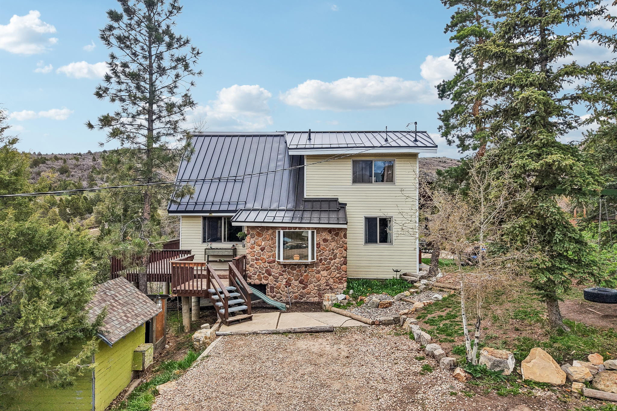 Situated on 1.10 acres in Kamas, this 5-bedroom, 3-bathroom home offers a rare combination of space, functionality, and extensive recent upgrades. With 2,620 square feet, the layout provides flexibility for a variety of living arrangements, including a separate mother-in-law setup. The home has been thoughtfully updated with major system improvements, including two furnaces (2023 and 2026), a new hot water heater (2025), a new well pump (2023), and a septic system that was inspected, pumped, and improved with a new access riser in 2023. A standing seam lifetime metal roof was installed, adding long-term durability and value. Interior updates include newly painted walls and updated appliances in both the main home and mother-in-law area, featuring two LG refrigerators, two LG electric stoves, and an updated LG washer and dryer. Outdoor spaces have been enhanced with flagstone pavers and artificial turf, creating a low-maintenance area ideal for relaxing or entertaining. This property offers a unique opportunity for those seeking acreage, updated systems, and versatile living space in a desirable Kamas location. Truck and Plow Included.
