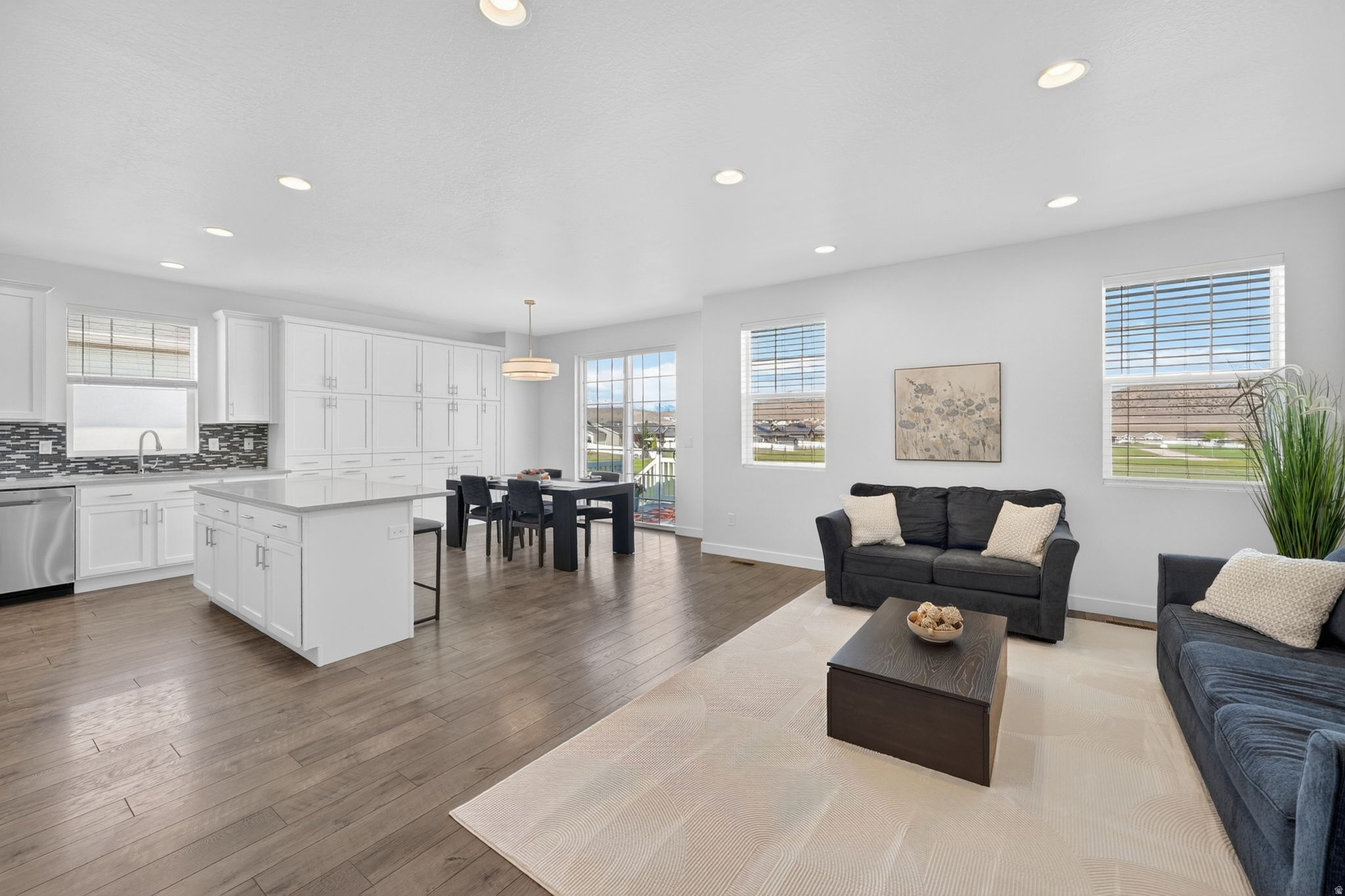 Welcome to Overland one of Eagle Mountain's most LOVED communities!  This stunning single-family home features 6 bedrooms, 3 bathrooms, and a rare 3-car garage with tons of storage throughout. The kitchen is packed with an incredible organization system and storage solutions that make cooking feel effortless. The open-concept layout creates the perfect flow for entertaining and everyday living, while the spacious primary suite on the main floor features a large bathroom with Duel shower heads and Quartz finishes with double sinks, glass shower and a walk-in closet you'll absolutely love. Downstairs you will find large bedrooms, a Kitchenette and space for Movie night with Surround Sound and setup for projector. Step outside to your gorgeous backyard with NO backyard neighbors, a beautiful deck perfect for morning coffee, summer nights, and watching the sunrise over the mountains.  Located in the heart of Overland, this neighborhood is packed with amenities including pump tracks, a community pool, clubhouse, parks, trails, and endless space for kids to play and explore. Homes like this in Overland don't come up often! Schedule your showing TODAY!