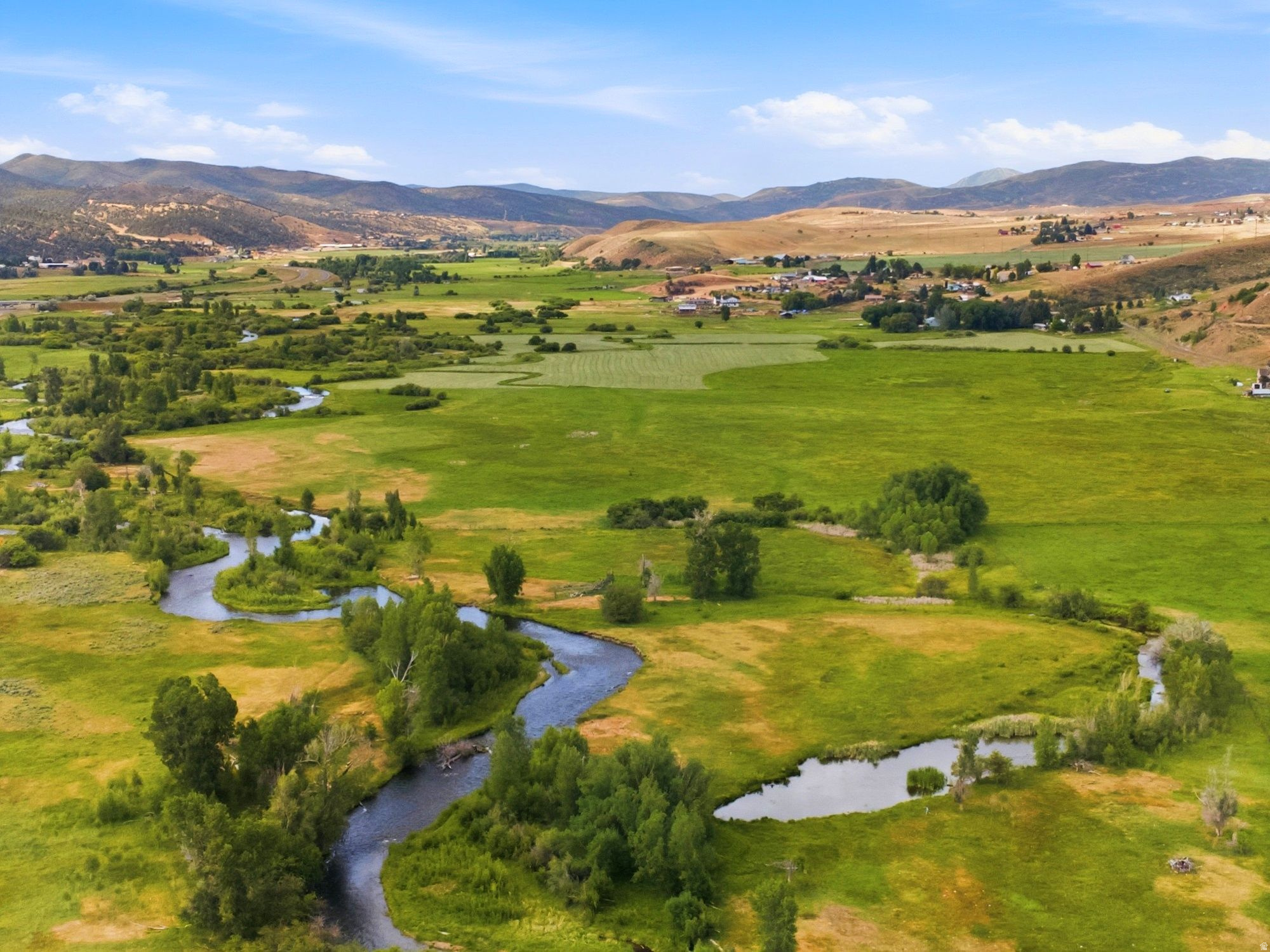 Proudly presenting WEBER VALLEY RANCH-a rare opportunity to own 40 breathtaking acres along the Weber River, just 15 minutes from Park City. This extraordinary property spans both sides of the river, offering exceptional privacy, sweeping mountain and valley views, and direct access to one of Utah's most iconic waterways.  The landscape features an exceptional blend of open meadows, mature vegetation, a natural pond, and more than 3,000 feet of river frontage along a picturesque tailwater section of the Weber River as it winds and meanders through the property. Favorable AG-10 zoning, together with a completed wetland delineation study, enhances the property's potential for multiple homesites and creates an ideal setting for a legacy ranch, private family compound, or thoughtfully designed luxury estate community.  With the potential for four approximately 10-acre estates, Weber Valley Ranch presents a compelling development opportunity while preserving the space, privacy, and natural beauty that define authentic mountain living.  Significant senior water rights will convey with the purchase, adding meaningful long-term value and creating exceptional possibilities for estate landscaping, agricultural use, equestrian amenities, and future development, subject to applicable approvals and regulations.  Enjoy private fly fishing, abundant wildlife, peaceful riverfront surroundings, and year-round recreation from your own property-all within easy reach of Park City's world-class skiing, dining, shopping, and entertainment. Properties offering this combination of acreage, senior water rights, development potential, and extensive Weber River frontage are increasingly rare. Weber Valley Ranch represents an extraordinary opportunity to create a timeless Summit County retreat and enduring generational legacy.  Buyer to verify all property information.
