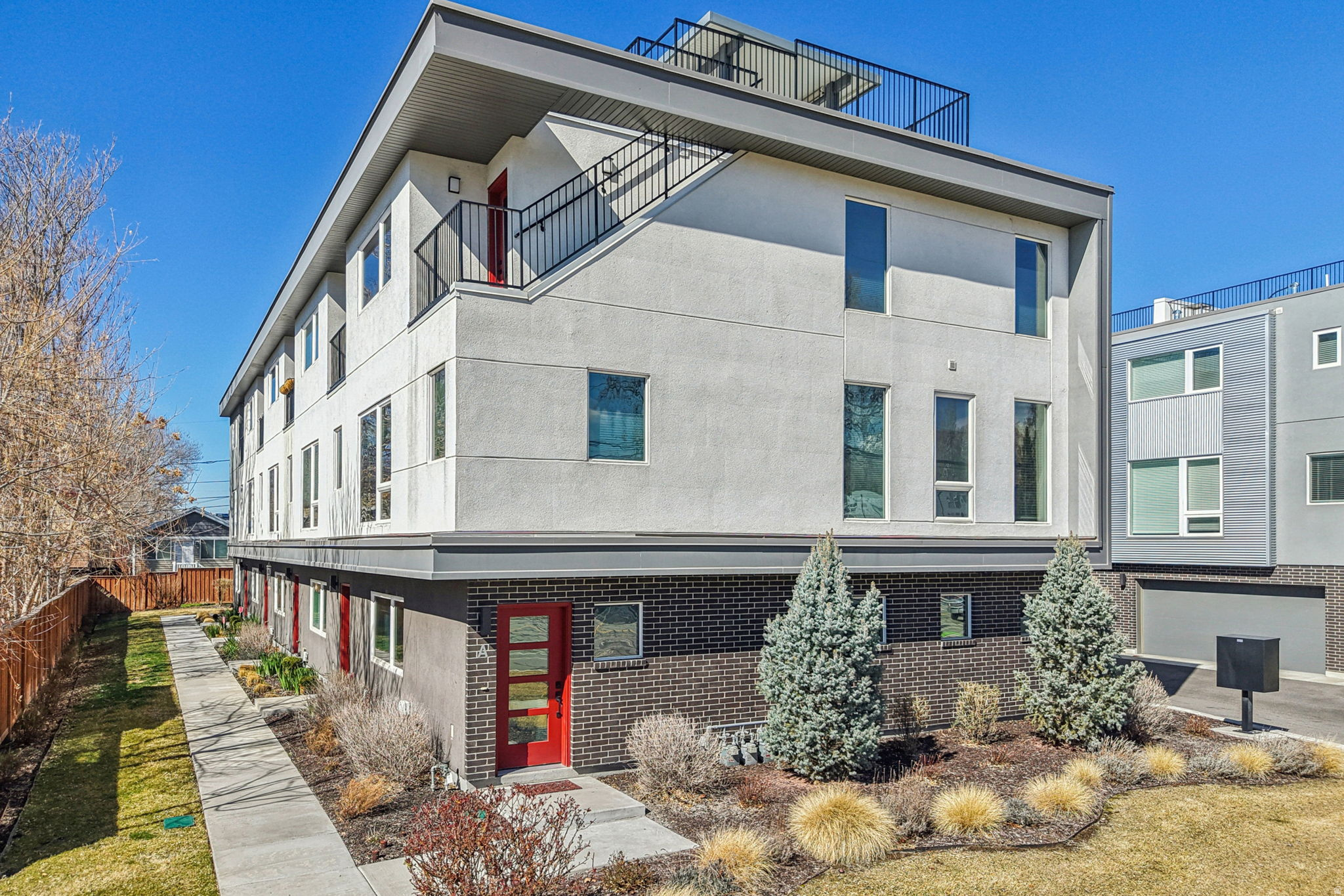 Discover the perfect balance of contemporary new-construction efficiency and timeless character in this stunning 2021-built luxury townhome. Located in one of Salt Lake City's most desirable, walkable neighborhoods, you're just steps from the vibrant Maven District (home to women-owned businesses, dining, and creative energy) and the eclectic shops, restaurants, and iconic charm of 9th & 9th. Weekend strolls to beautiful Liberty Park are effortless-urban convenience meets relaxed city living.  This energy-efficient residence checks every box for modern living: ductless HVAC with individual room controls, low-E windows, a heat exchanger, and a tankless water heater keep utility costs low and comfort high. High-end finishes and thoughtful design elevate every space.  Inside, enjoy three generous ensuite bedrooms-each with a walk-in closet-including a versatile third bedroom ideal as a creative home office or guest suite. The open-concept main level flows seamlessly from a show-stopping contemporary kitchen (featuring a large quartz-topped island, premium stainless steel GE and JennAir appliances, and a double-door pantry) into the bright living and dining areas. Nine-foot ceilings and abundant natural light create an airy, inviting atmosphere perfect for everyday life and effortless entertaining.  Breathe easier with a whole-home air purification system, and charge ahead with two 220V EV chargers in your attached two-car garage. Step outside to your private 400 sq ft rooftop deck-an entertainer's dream-fully landscaped with an extensive drip irrigation system and plumbed for future outdoor amenities. Soak in 360-degree city views, golden-hour happy hours, summer fireworks, and breathtaking sunsets from your own elevated oasis.  This particular unit shines with exceptional custom upgrades that set it apart:  Striking custom floor tiles, designed and imported from Mexico, grace the entry level with unique personality and style. Playful, whimsical wallpaper treatments add delightful character throughout. Designer custom light fixtures and upgraded window coverings enhance every room. Thoughtful plumbing ready for rooftop enhancements. Move-in ready never looked (or felt) this good. Experience cutting-edge luxury with soul in a location that truly has it all. Schedule your private tour today-this special townhome won't last long! *Buyer is advised to obtain an independent measurement. Buyer/Buyers Agent to verify all info including sq. ft.