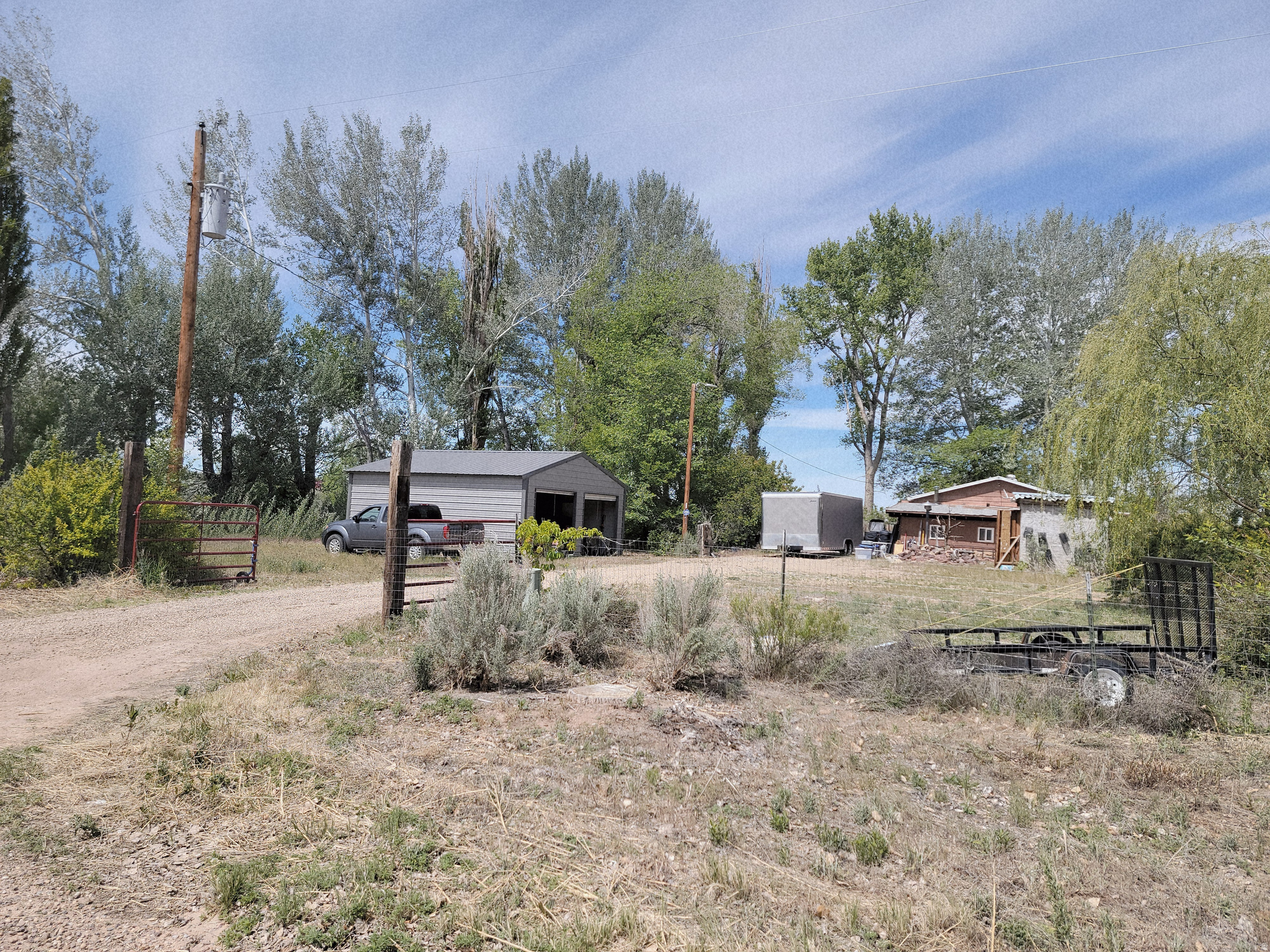 The possibilities abound with this lovely, shady, horse property. The older, but nicely updated, home was originally a 3 BR, 1 BA home, but one BR was demolished in order to make the living area larger. This could be reverted to its original floorplan, or possible converted into a primary BR.  The house is tucked back into a lot which itself is to die for, with mature trees, including fruit trees, flowering bushes, a historic cabin and plenty of large buildings which could be used for storage, a workshop or whatever. Irrigation runs right through the property! Deer, turkey and racoons are frequent visitors and the sunsets are second to none. Just north of the Merc in Randlett!Square footage figures are provided as a courtesy estimate only and were obtained from county tax records.  Buyer is advised to obtain an independent measurement. There are 13 tax parcels included in this listing. The acerage listed is the combined estimate.