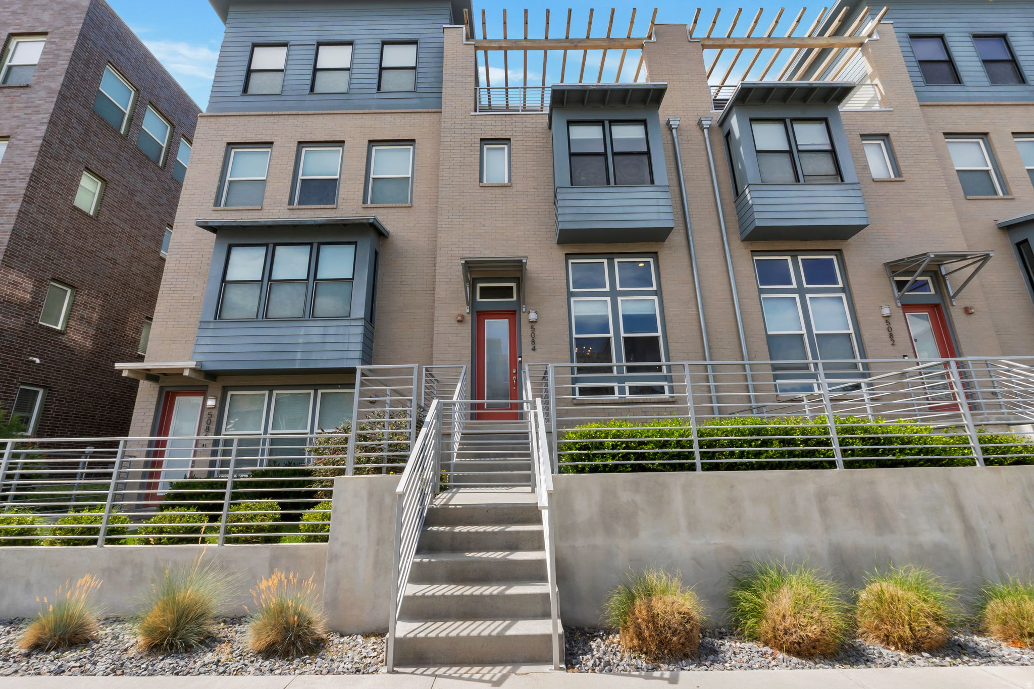 Beautiful Daybreak townhome with so many upgrades! Huge covered sky deck on top floor with amazing views. Great for relaxing and entertaining. On the same floor as the sky deck, you will find a huge family room and 1/2 bath. Plumbed up there for a wet bar. Coming down you have bedroom floor with 3 well apportioned bedrooms, including a primary with a walk in closet and en suite with double sinks and beautiful euro shower. Main bath with over sized soaker tub and shower.  Wow! Laundry on this level also. Shiny quartz counter tops throughout. Durable and nice laminate flooring from the entry up thru the dining room and kitchen. Balcony on the back of home also. Stainless appliances all stay in kitchen. Vaulted ceilings and well lit. Over 400 feet of storage in unfinished basement. Some units have set this up as a workout room. Metal railing upgrades make this unit modern and functional.  Come and check it out right now!