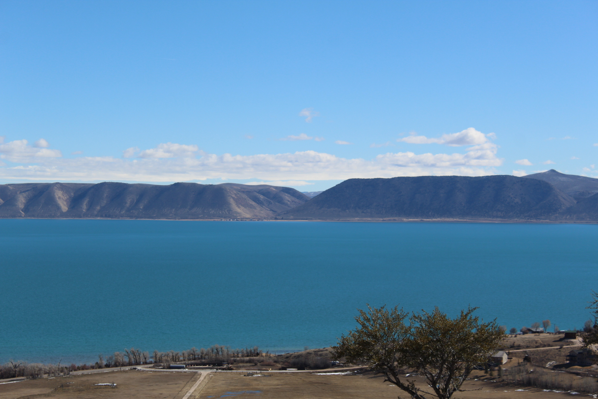 BRING YOUR OFFER! Just imagine sitting on your deck taking in the fresh air just watching the blue water and the wildlife that surrounds you. This GORGEOUS VIEW lot is on the top row in the highly desired Swan Creek Village at Bear Lake with year-round access. Nothing in front of you so take in all the views of the lake and mountain backdrop. Mature cedar trees, gradual slope with flat space to build your dream home or cabin. Close to everything you need at the lake including the Raspberry shakes. Water, power and sewer are in the road ready and waiting for you to build your dream home or cabin. Gas is propane with a resident provided tank. Please call with questions. Go and show!