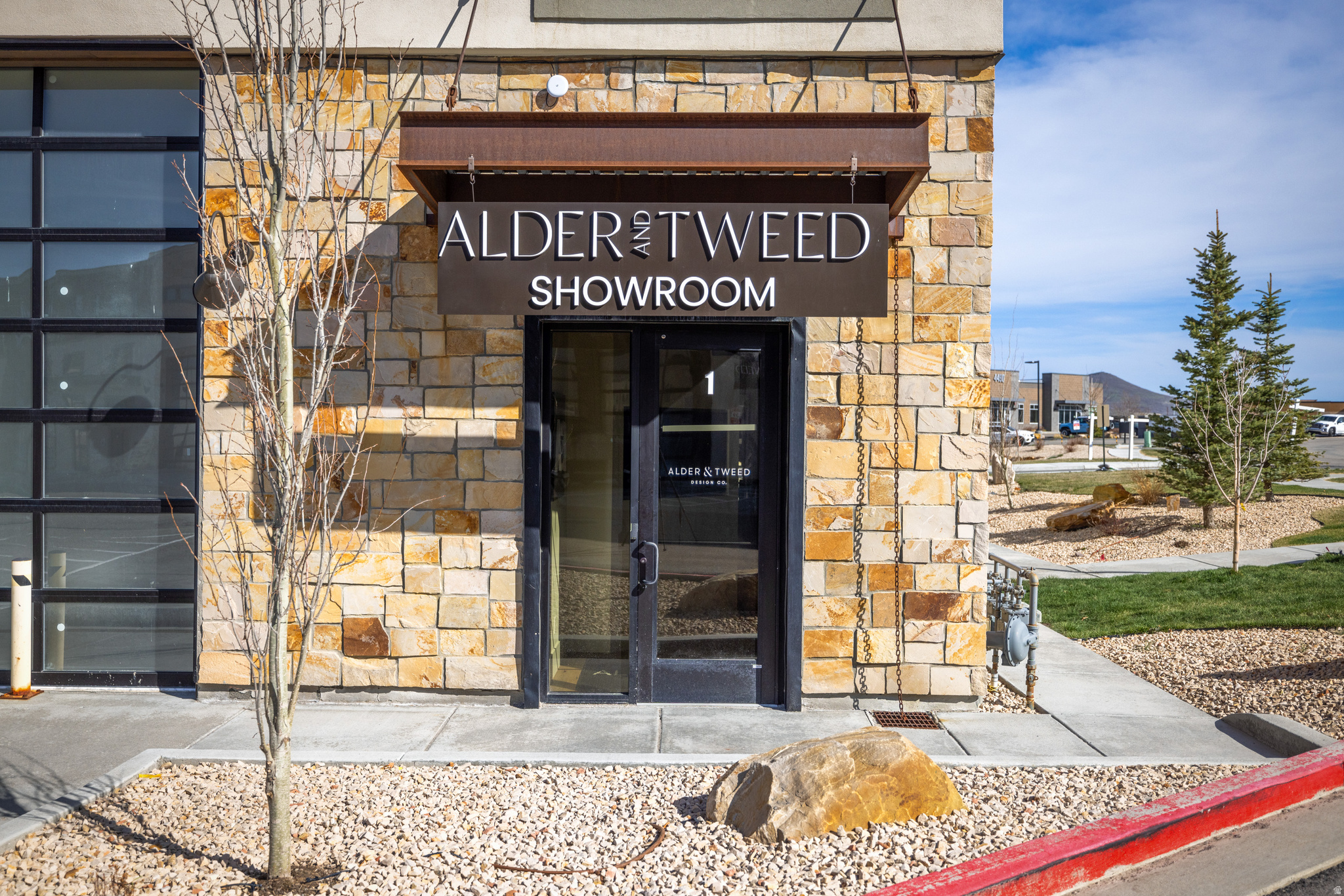 Welcome to 4554 N Forestdale Drive, Unit A1, Park City, UT 84098 an exceptional opportunity to lease or to Purchase one of the finest finished end units in the development. Positioned at the entrance to the community, this premier location offers outstanding visibility, convenience, and a professional presence.  Privately owned and thoughtfully designed by Alder & Tweed, Park City's renowned interior design firm, the space features custom built-ins and elevated finishes that create a sophisticated environment throughout. Encompassing approximately 3,600 square feet, the property offers a highly versatile layout with luxury office, residential, and warehouse space, including approximately 1,800 square feet dedicated to beautifully appointed residential living.  The residential portion is equipped with premium appliances from Sub-Zero, Wolf, and Viking, delivering both exceptional performance and timeless design. Previously utilized as Alder & Tweed's showroom, the property showcases high-end craftsmanship, designer finishes, and meticulous attention to detail in every space.  Additional features include a state-of-the-art HVAC system with integrated scent diffusion, a luxury lighting package, and modern audiovisual technology, creating an environment that is both functional and refined. Whether you're seeking executive office space, luxury live/work accommodations, showroom space, warehouse functionality, or a combination of all four, this property offers remarkable flexibility.  Rarely does a lease opportunity become available with this level of design, finish quality, and versatility. Schedule your private tour today and experience everything this one-of-a-kind Park City property has to offer.
