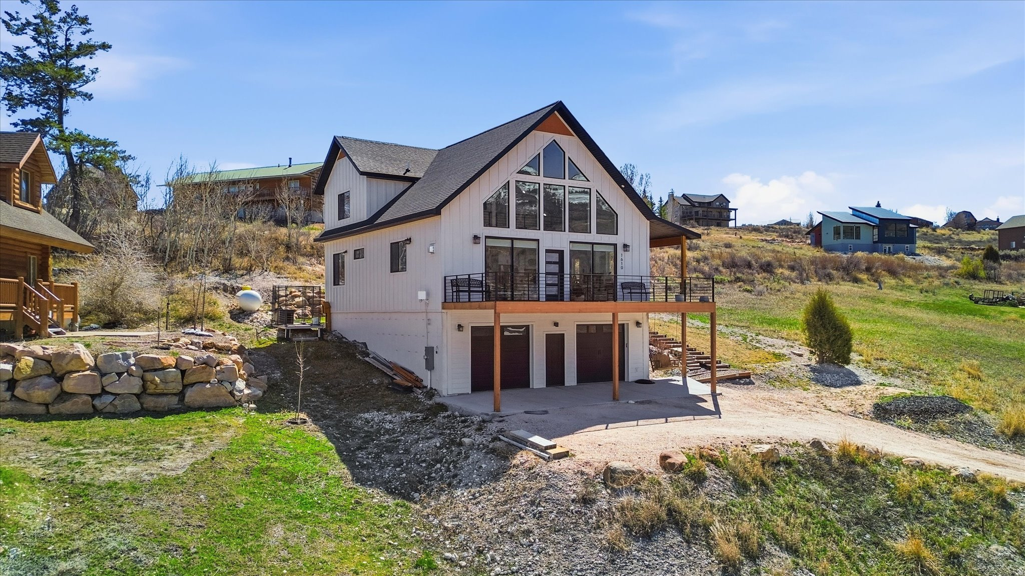 Huge Price Adjustment!!  Stunning Custom Home in Gated Swan Creek Village --- Unforgettable Bear Lake Views --- Imagine waking up to breathtaking sunrises over Bear Lake from your expansive wraparound deck, or unwinding on the private balcony off the primary suite as cool evening breezes roll in. This beautifully crafted custom home sits proudly on the hill in the gated community of Swan Creek Village, just moments from the Bear Lake Marina State Park. Inside, every detail reflects true custom quality and high-end finishes. Warm natural wood beams grace the great room, creating an inviting space perfect for gathering. The stunning kitchen shines with premium Silver Falls Granite counters and a striking backsplash imported from Italy. A cozy fireplace anchors the living area-ideal for winter holiday get-togethers and making lasting memories with friends and loved ones. The flexible floor plan offers 5 bedrooms, including a standout flex room with a wet bar that can easily become a family room, home gym, or whatever suits your lifestyle. You'll also love the luxurious main-floor laundry and mudroom-perfect for hanging lake towels and gear after a day on the water. Other unique touches include a bougie sauna topping off the custom finishes found nowhere else, adding that extra layer of relaxation and exclusivity. Built to embrace the peace and beauty of Bear Lake life, this home delivers year-round enjoyment-from vibrant summer days at the marina to serene winter evenings by the fireplace. If you're looking for a true custom retreat in one of the area's most desirable gated communities, this is it. Come experience the views, the craftsmanship, and the lifestyle for yourself.