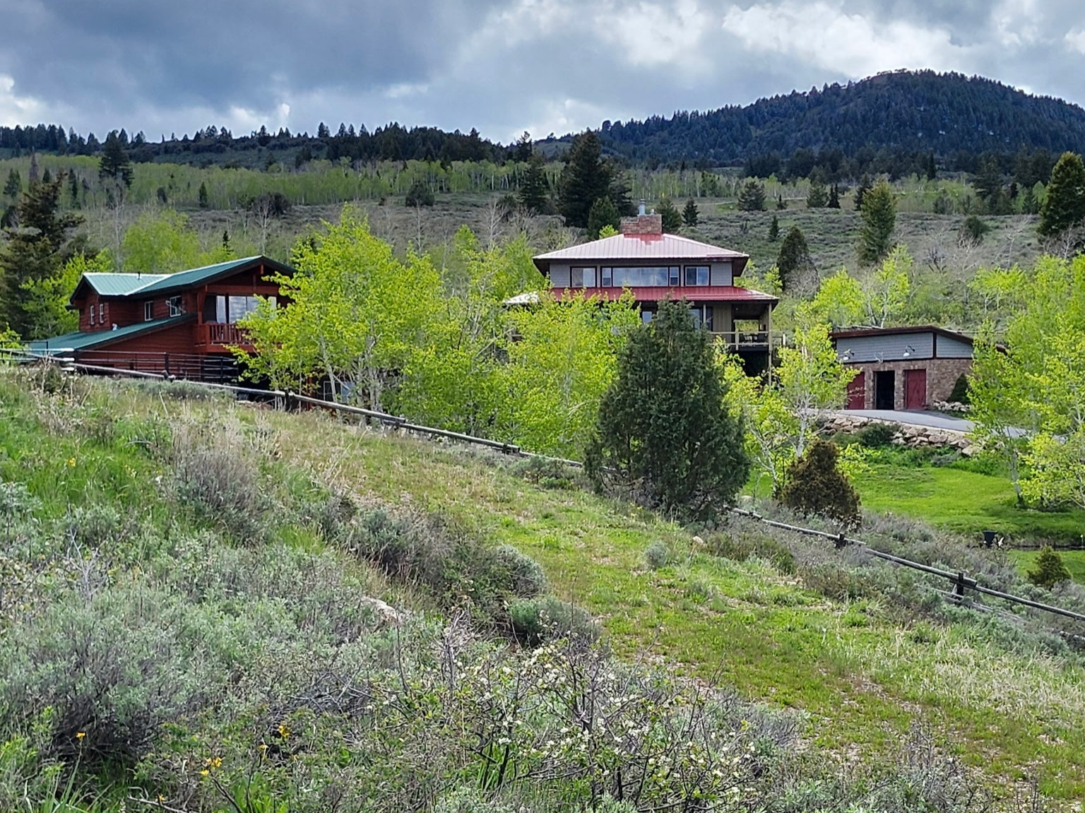 Must-see storybook estate in Bear Lake, offered as one combined property with two separate tax parcels. This rare Bear Lake retreat includes a beautiful main home, a large  barn with ADU  living quarters and flexible-use space, a three-car detached garage, and the kind of privacy, beauty, and direct outdoor access that is difficult to duplicate.  The home features a warm and inviting layout with a chef's kitchen, well-appointed living spaces, two laundry areas, and a large covered deck overlooking the property and Bear Lake. Imagine relaxing on the deck while ducks move across the pond, deer pass through the property, and moose occasionally come in to drink - a peaceful setting that feels private, natural, and truly special.  For those who love horses and the outdoors, this property is especially unique. Bring your horses and ride directly from the property to nearby trails and thousands of acres of National Forest - no trailering required. The property also includes 4 horse stalls, round pen and arena, making it well-suited for horse owners and outdoor enthusiasts.  The large 4 stall  barn adds tremendous flexibility, with ADV living quarters, space that could be used as an art studio, exercise room, recreation room, or hobby area, plus ample storage for a boat, side-by-sides, equipment, and other outdoor toys.  Additional highlights include an English garden, your own raspberry patch, a water softener, and a location only about 10 minutes from Beaver Mountain. A truly special Bear Lake view property offering the feel of a private estate, the functionality of a horse property, abundant storage and recreation space, and immediate access to some of Northern Utah's best outdoor recreation. Property is being sold as one combined offering and includes two separate tax parcels: Lot 31 and Lot 32. Buyer to verify acreage, tax ID information, zoning, utilities, access, and all intended uses.