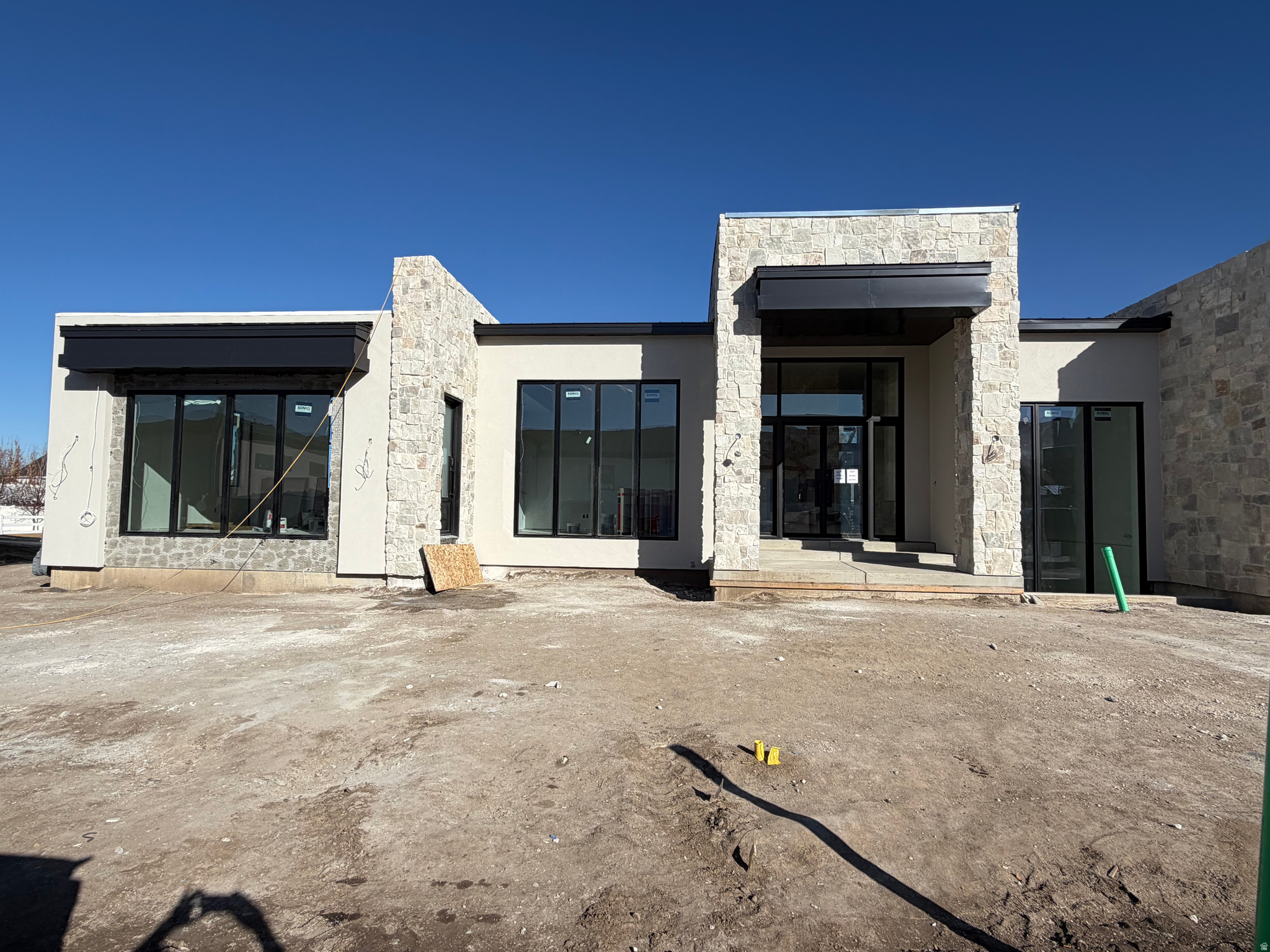 This extraordinary custom-built residence offers approximately 9400 square feet of living space, thoughtfully designed to blend luxury, comfort, and functionality at every turn. A standout feature of the property is the oversized five car garage, with electric and RV charge stations expertly configured to accommodate not only multiple cars but also a full sized RV and boat-garage perfect for those who value both convenience and adventure,. At the heart of the home lies a truly exceptional primary suite, designed as a private retreat.  This luxurious sanctuary features a cozy fireplace and direct access to the backyard through expansive sliding glass doors, creating a seamless indoor-outdoor living experience. The spa inspired primary bathroom elevates daily living with his and her vanities, his and her separate toilet rooms, heated tile floors, and an expansive skylight to let in natural light.  A spacious walk in steam shower and a freestanding soaking tub serves as a striking centerpiece, complemented by a dedicated sauna room with a custom built hybrid sauna featuring traditional wet stone, infrared and red light therapy, and an invigorating cold plunge for the ultimate wellness experience.  The primary suite continues to impress with an expansive his and hers walk-in closet.  Thoughtfully designed, the closet provides direct access to a well appointed laundry room equipped with 2 washer and dryers and a steam closet.  A spacious flex room offers endless possibilities- ideal for a media room, private fitness studio, or personalized retreat tailored to your lifestyle. The home is nothing short of inspiring, featuring expansive glass windows that flood the space with natural light while framing the beautiful outdoor views and gorgeous hardwood floors throughout the main level.  At the center of the home, a grand living room that welcomes you with a stunning custom fireplace, serving as both a focal point and a warm gathering space. The living area, like the bedroom offers direct access to the backyard with expansive sliding glass doors that invite you to the covered backyard patio living space and dining space equipped with built in heaters and misters, again seamlessly blending the outside with the inside.  The living area flows seamlessly into a breathtaking gourmet kitchen, meticulously designed with both beauty and performance in mind.  Highlights include elegant white oak cabinetry, taj-mahal countertops, a massive skylight that bathes the space in natural light, dual refrigerators, 3 work station sinks and 3 dishwashers for added convenience,  an oversized island complete with two faucets and a built-in workstation sink-perfect for everyday living.  And serving as the focal point of the kitchen is a stunning and unique hood vent made of natural stone tile.  A fully equipped butlers pantry enhances both storage and prep space, making hosting effortless, while the kitchen transitions naturally into a spacious dining area-creating a cohesive and inviting environment for gatherings large and small.   The main floor also showcases a beautiful home office complemented with glass door and windows to provide the perfect combination of openness and privacy. The main floor is completed with a private guest suite that feels like a home within a home. Perfect for extended family, long-term guests, or live-in accommodations, this beautifully appointed space offers it own private entrance from both the exterior and interior of the home, ensuring comfort and independence.  The guest suite features a stylish wet bar, a spacious walk-in closet with a washer and dryer that provides ample storage while the grand en-suite bathroom creates a true retreat with high end finishes. The custom-designed basement of this home is a true extension of its luxury and livability, featuring soaring 10-foot ceilings and an expansive open-concept layout that creates a bright, airy feel rarely found. Designed for both entertaining and everyday comfort, the