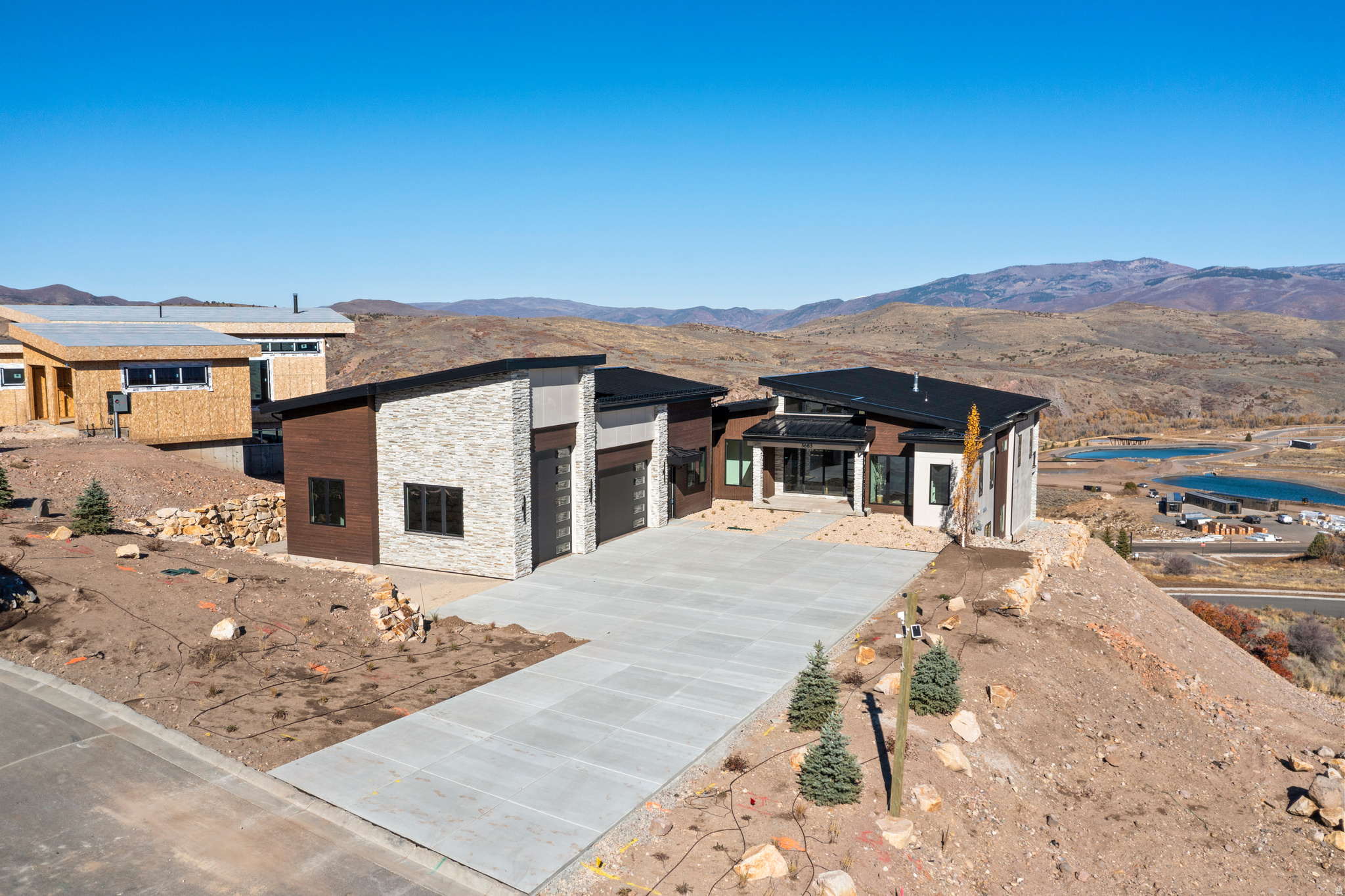 Your wait to own a Luxury Mountain Retreat in Benloch Ranch | Heber City for under appraised value is over!  Welcome to one of Benloch Ranch's most stunning and unique homes-where modern luxury meets mountain serenity-a custom-built masterpiece completed Nov of 2025. Spanning over 8,300 sq ft, this architectural masterpiece is designed for elevated living. The home features 7 bedrooms, 8 bathrooms, a private movie theater, exercise room with sauna, and two kitchens with 1 outdoor kitchen.   From the moment you enter, you'll be captivated by breathtaking panoramic views through expansive accordion patio doors that blend indoor and outdoor living seamlessly. The main kitchen is a chef's dream, featuring a Wolf cooktop and double ovens, Sub-Zero fridge and freezer, two dishwashers, and a walk-in butler's pantry-perfectly suited for entertaining.  Enjoy movie nights in the private theater, recharge in the exercise room and sauna, or host gatherings on the expansive back deck complete with a full outdoor kitchen and gas fireplace. What truly sets this home apart is the heated and air conditioned 1,597 sq ft indoor sports court located under the garage-offering year-round recreation for basketball, pickleball, and volleyball, regardless of the weather.  To top it all off, the radiant-heated driveway ensures you'll never need to shovel snow again.  Perfectly situated for adventure and relaxation, this home is just minutes from Jordanelle Reservoir, where you can enjoy boating, water skiing, and fishing, and close to the Marcella Club, featuring Tiger Woods' new TGR Design golf course. You're also just a short drive from world-class skiing at Deer Valley Resort, the charm of Historic Main Street in Park City, and Jordanelle Ridge.   With full vacation rental zoning, this home offers exceptional investment potential or the ultimate luxury retreat for you and your guests. Don't miss your opportunity to own this nearly finished one-of-a-kind mountain estate in one of Utah's most desirable new communities.  Schedule your private showing today.  Square footage figures are provided as a courtesy estimate only and were obtained from building plans .  Buyer is advised to obtain an independent measurement.